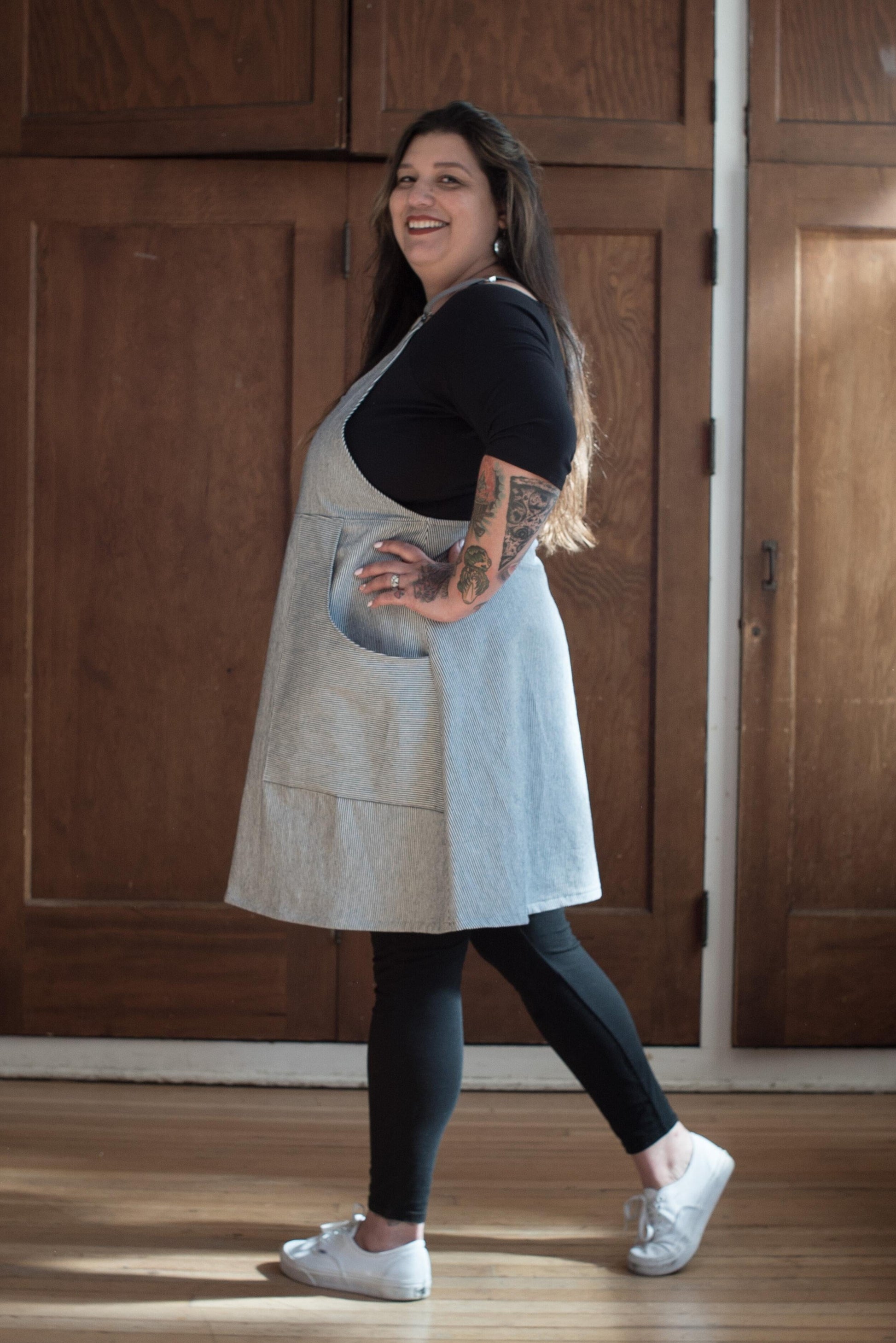 Model at 3/4 view Railroad Stripe Suspender Dress.