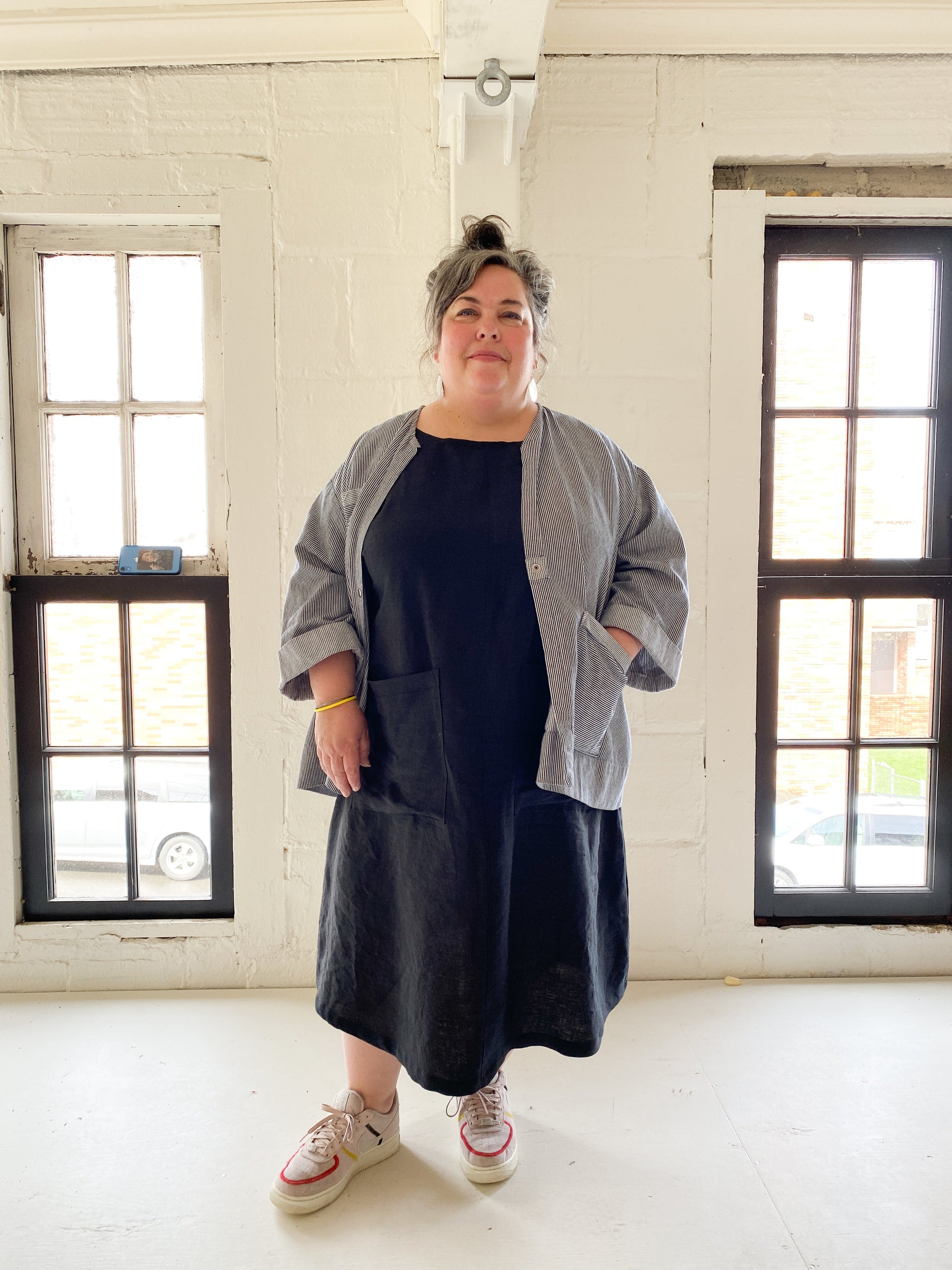 A-line, longer linen dress has two big patch pockets on the front. With lab coat.