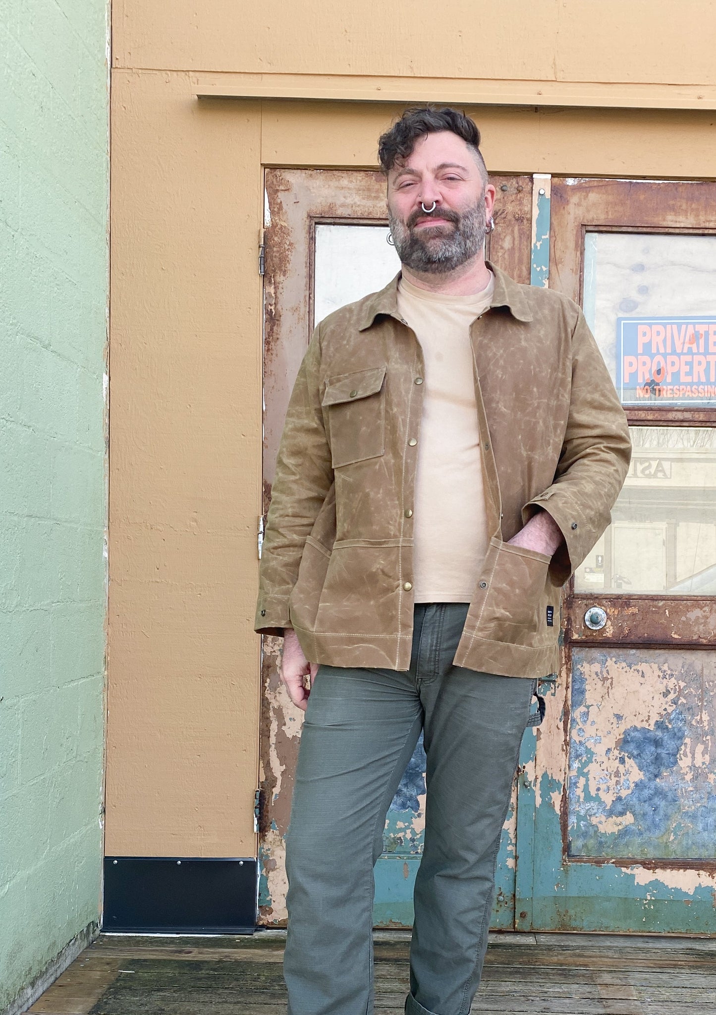 Model in Waxed Canvas Work Jacket in tan, unbuttoned.