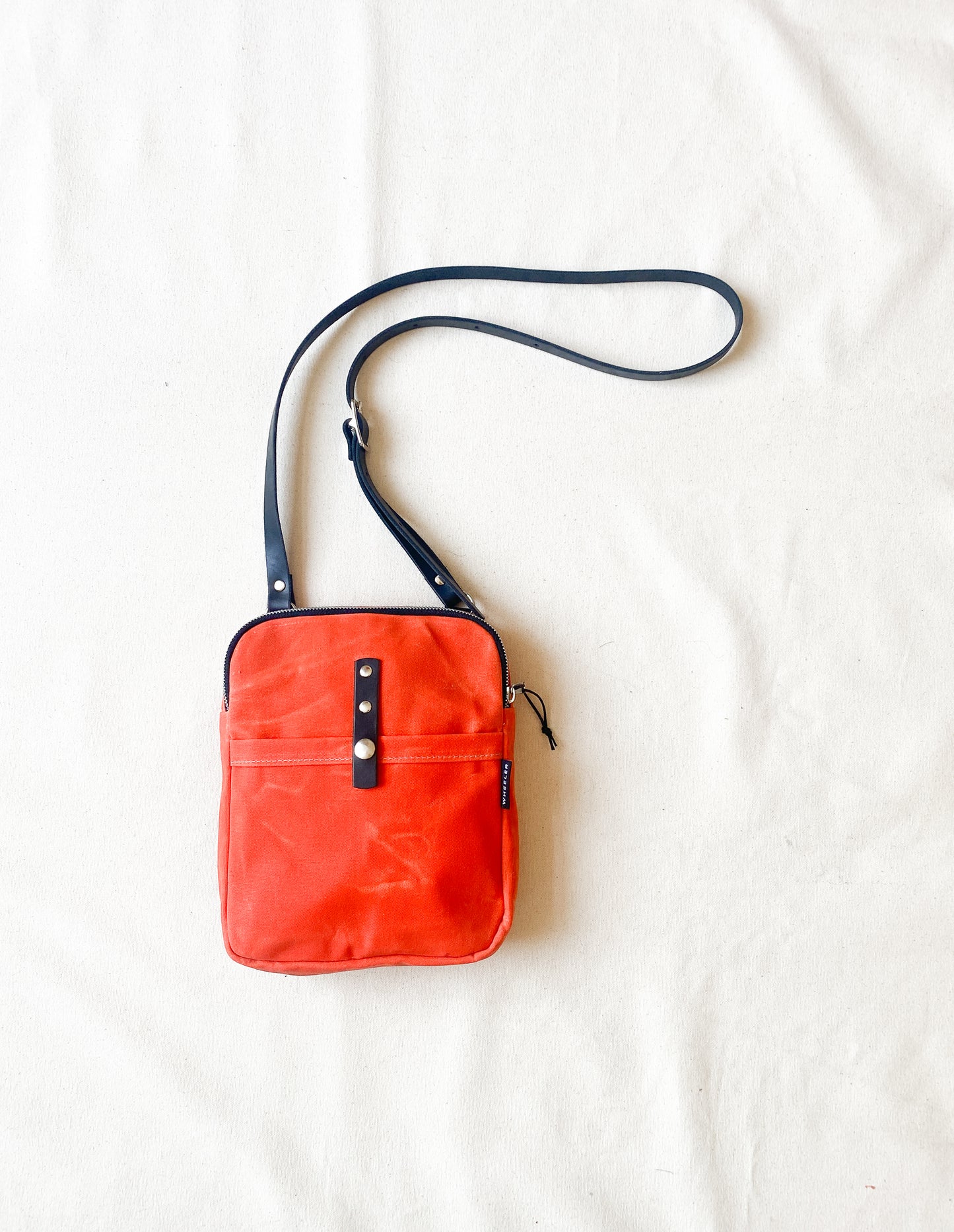 Waxed Canvas Mini Messenger in red.