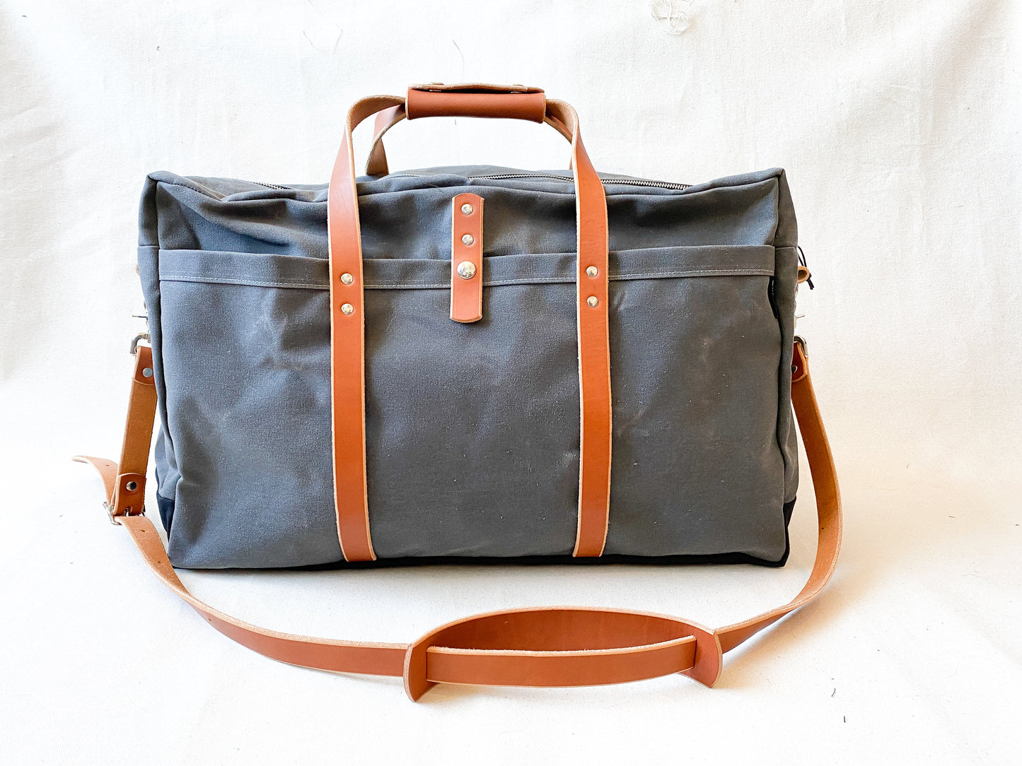 Carry on Duffel in slate and light brown leather.