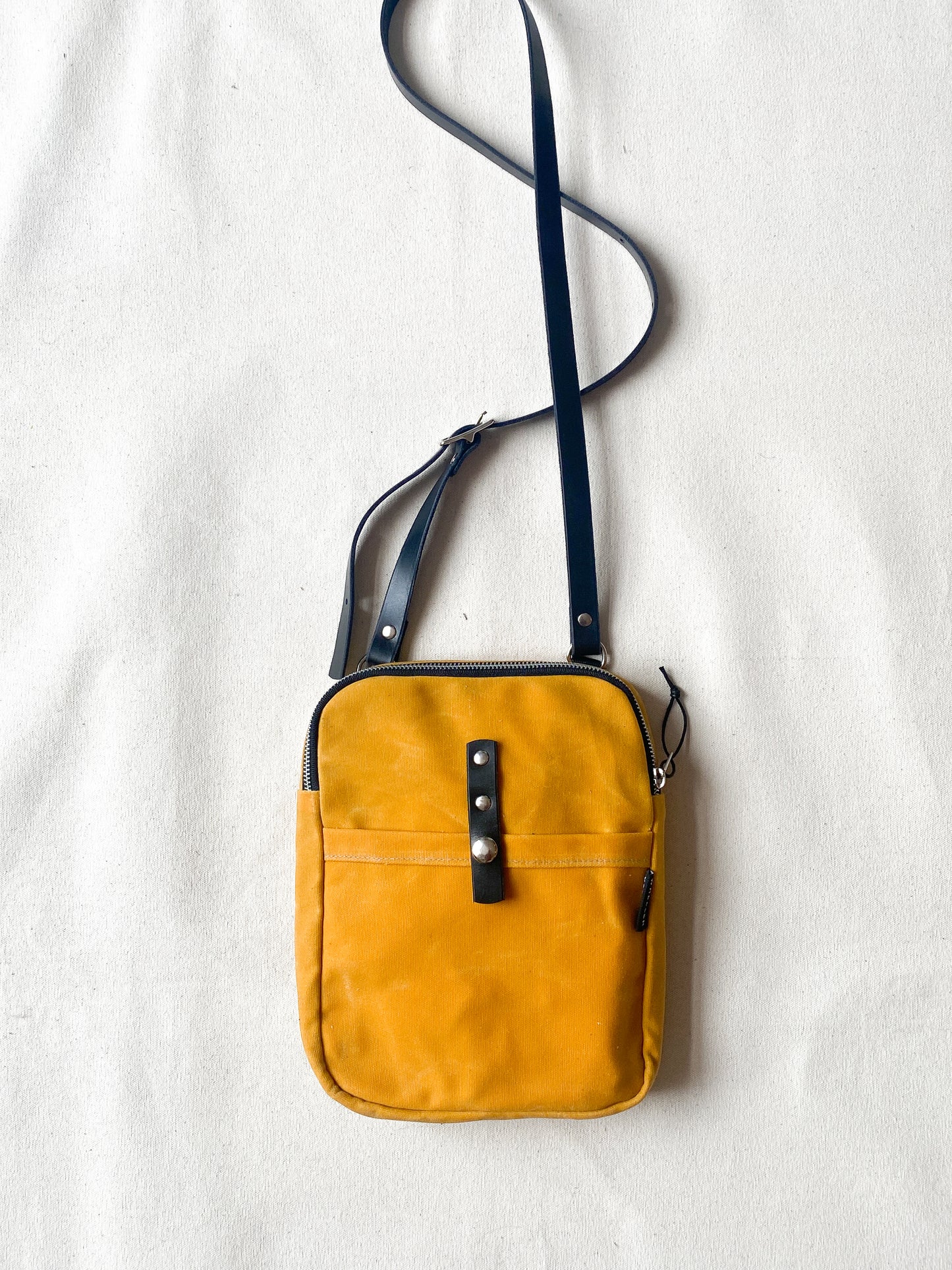 Waxed Canvas Mini Messenger in yellow.
