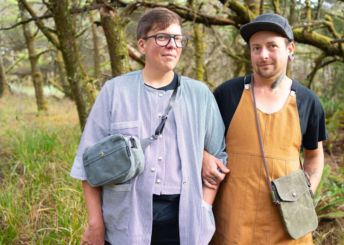 A queer couple decked out in Shift + Wheeler goods. All handmade in Astoria, Oregon, USA
