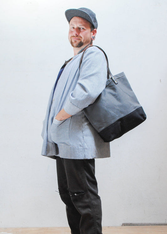 The utility tote has handles long enough so you can sling the bag over your shoulder.