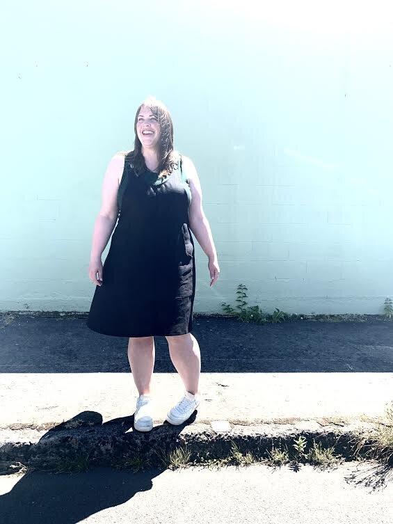 Model wearing black linen suspender dress. this 100% linen, 7oz (medium weight) is super SUPER soft, flowy, and has a very nice hand. Slightly nubby weave gives it character and texture.