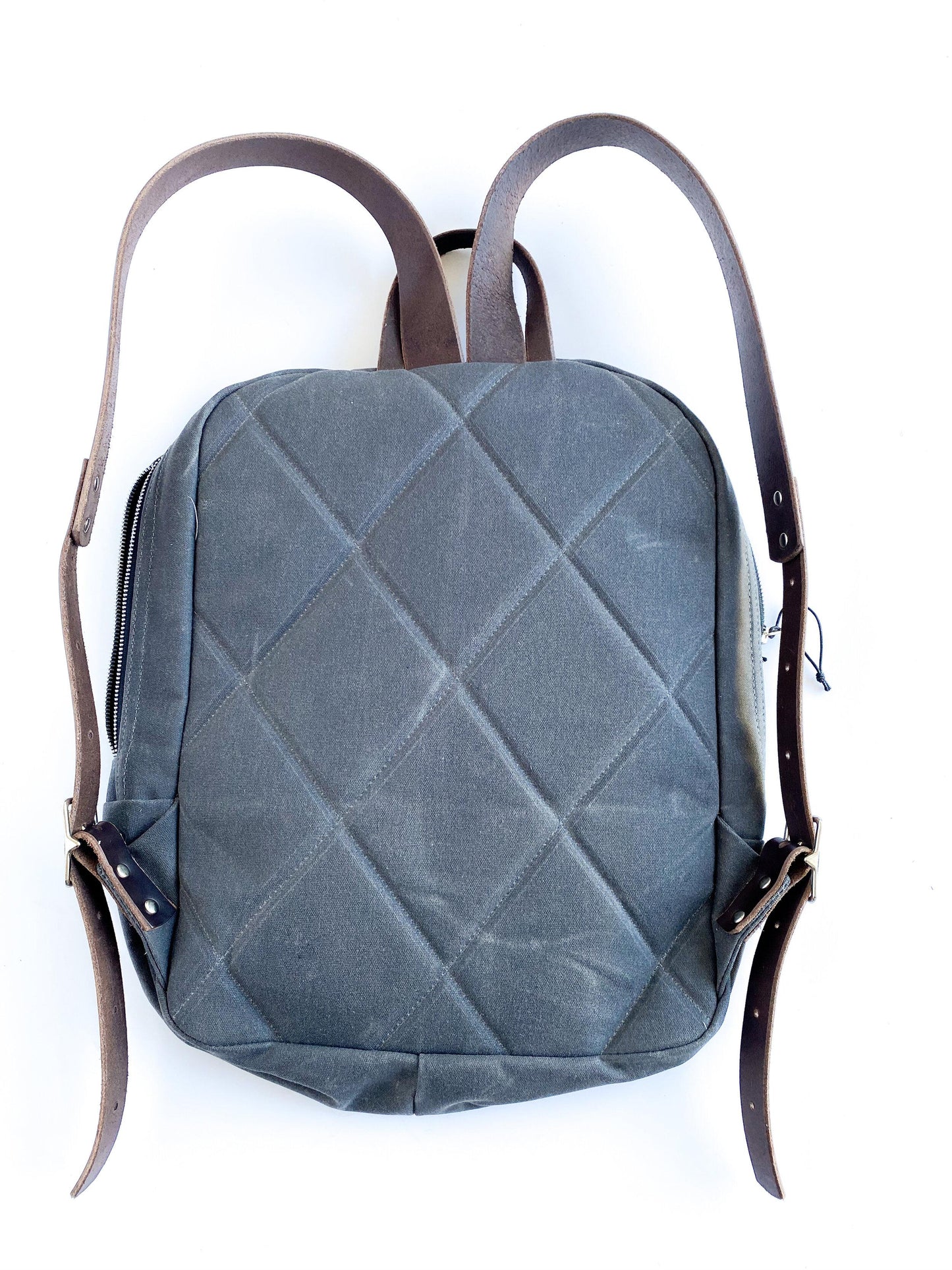 Waxed canvas backpack, quilted back detail.
