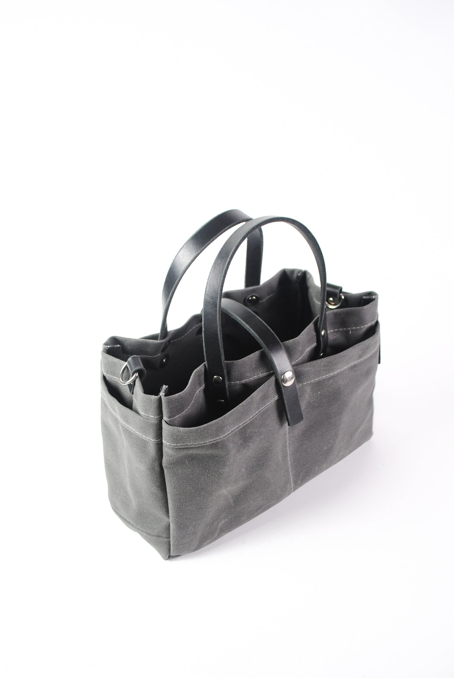Charcoal, waxed cotton canvas tool bag, side view.