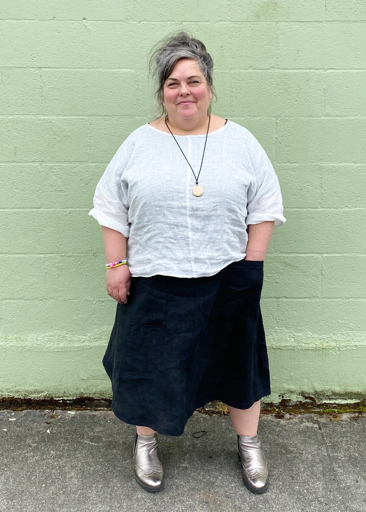 Ghost shirt worn as layering piece over tank top, styled by Shift + Wheeler