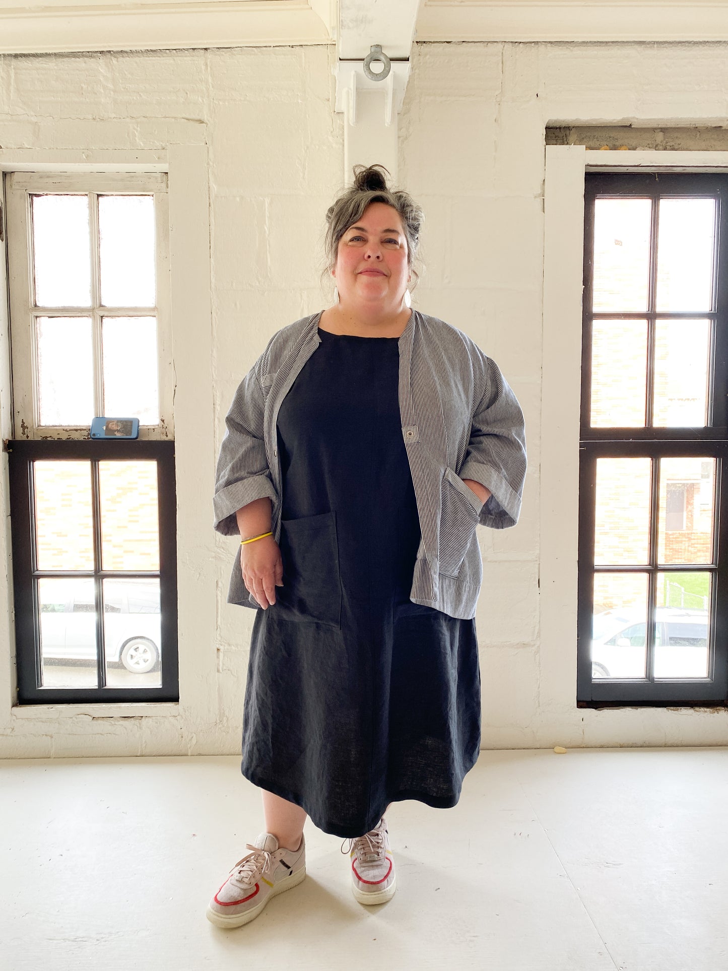 A-line, longer linen dress has two big patch pockets on the front. With lab coat.