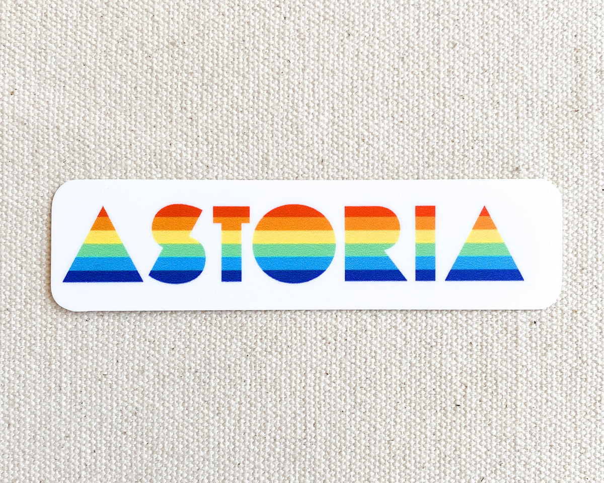 Sticker that reads "ASTORIA" with rainbow flag colors in the text