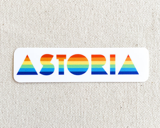 Sticker that reads "ASTORIA" with rainbow flag colors in the text