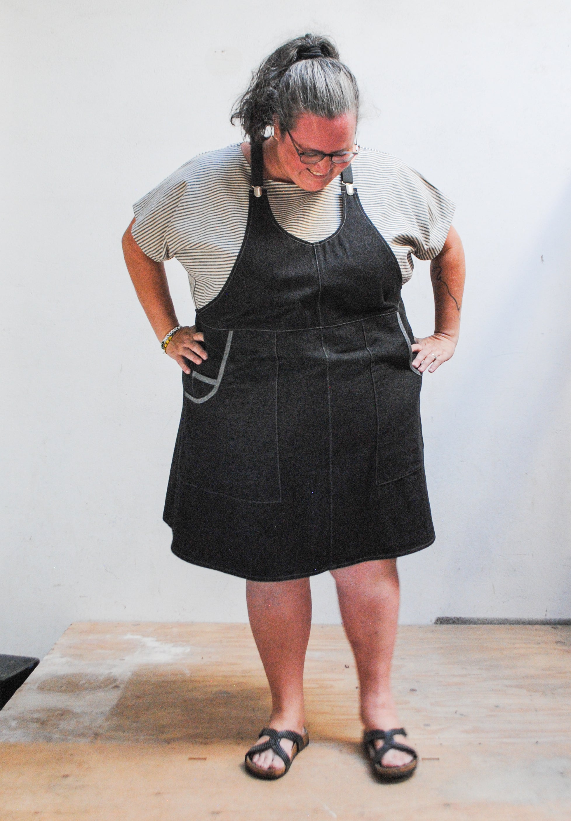 Black denim apron dress with adjustable grey suspenders, handmade in Astoria Oregon