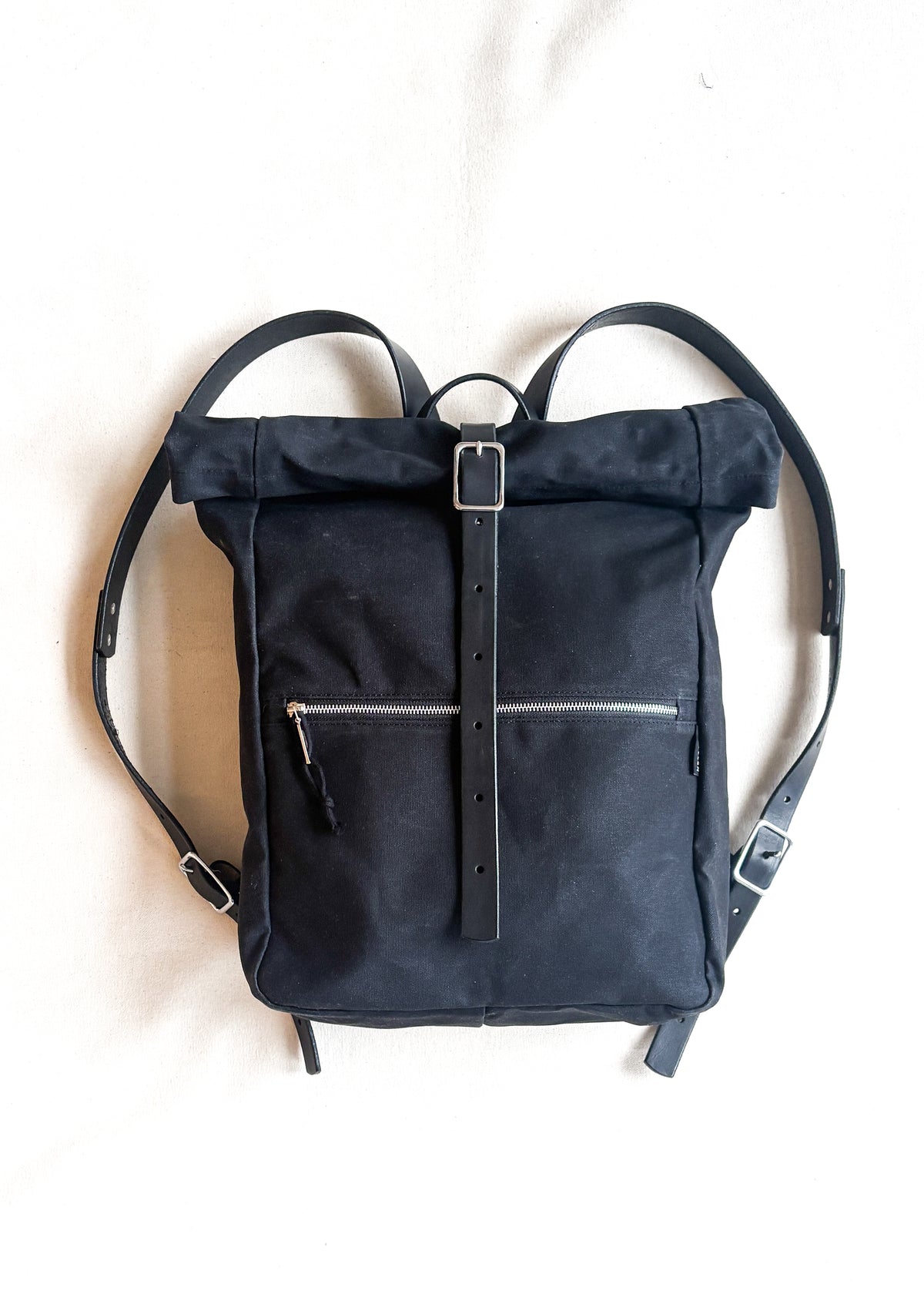 Black waxed canvas and leather rolltop backpack