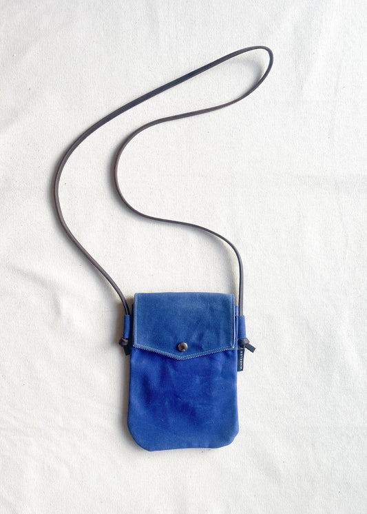 Shift + Wheeler waxed canvas crossbody bag in royal blue with bridle leather strap