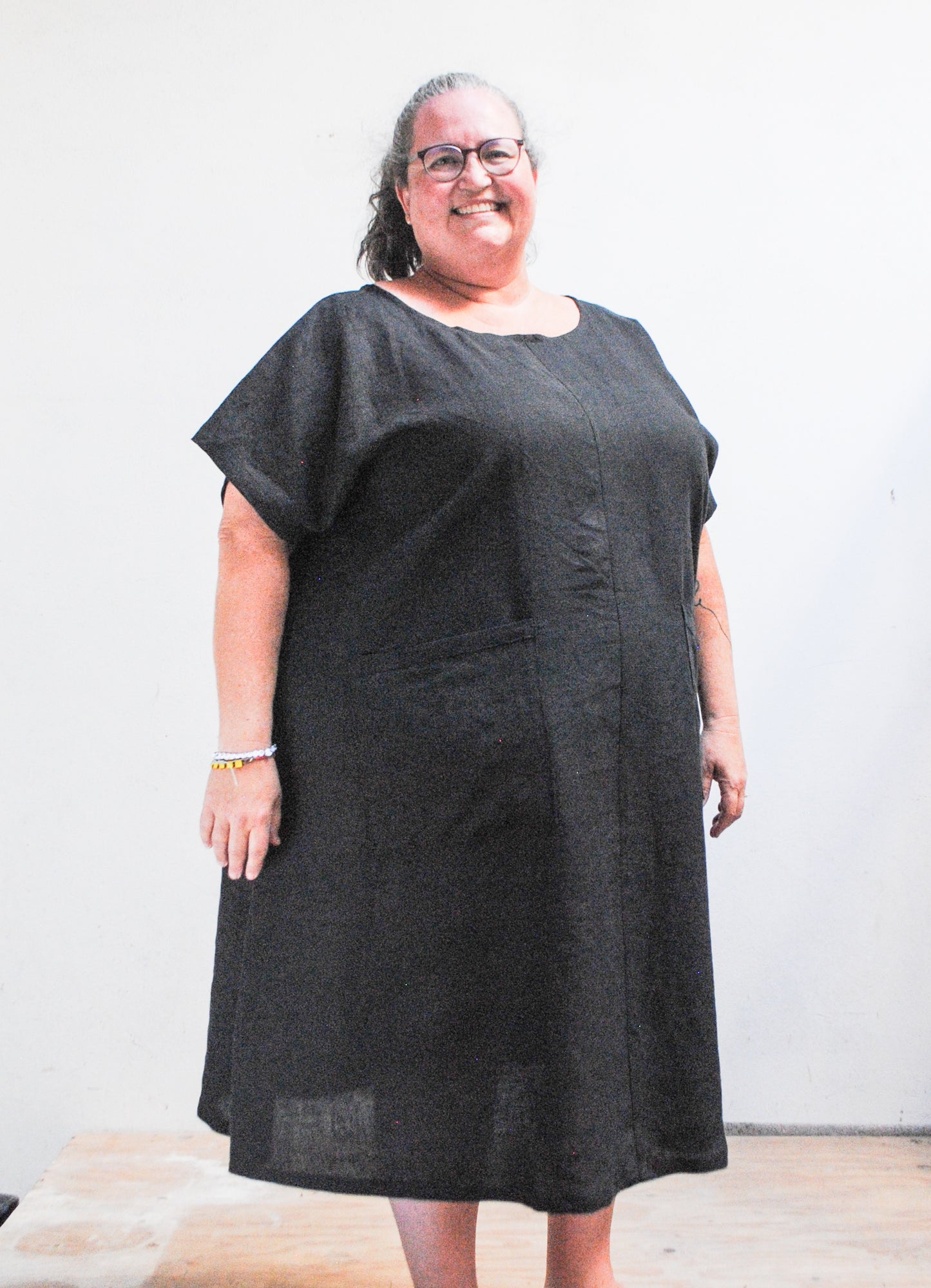 Handmade black linen A-line dress with patch pockets, front view, made in Astoria Oregon USA