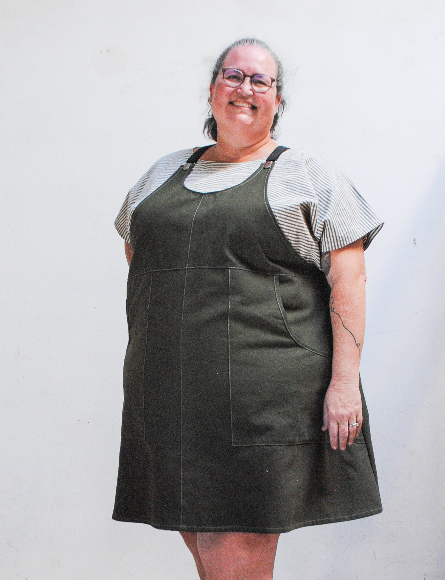 Black adjustable suspenders on evergreen cotton suspender dress by Shift + Wheeler