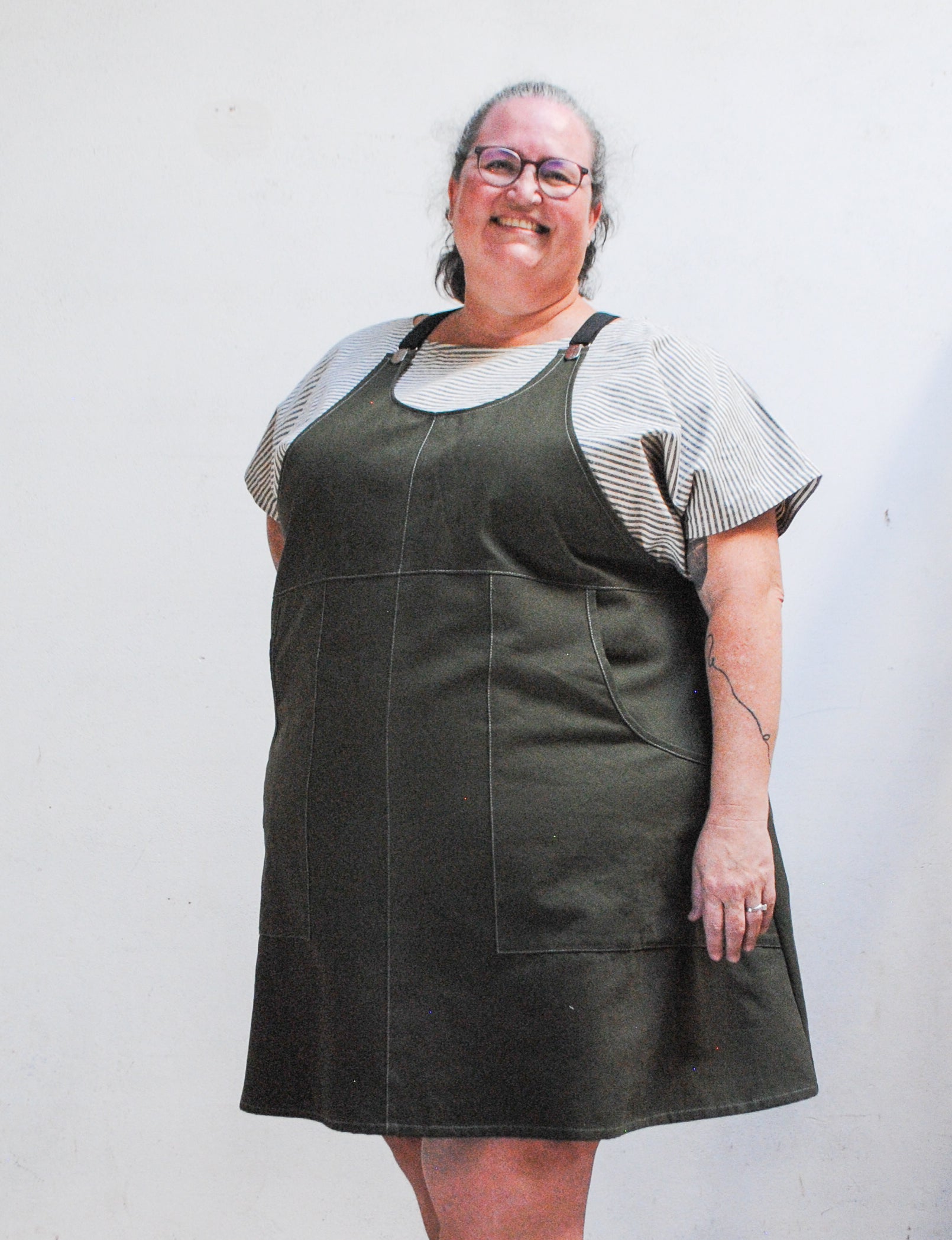 Black adjustable suspenders on evergreen cotton suspender dress by Shift + Wheeler