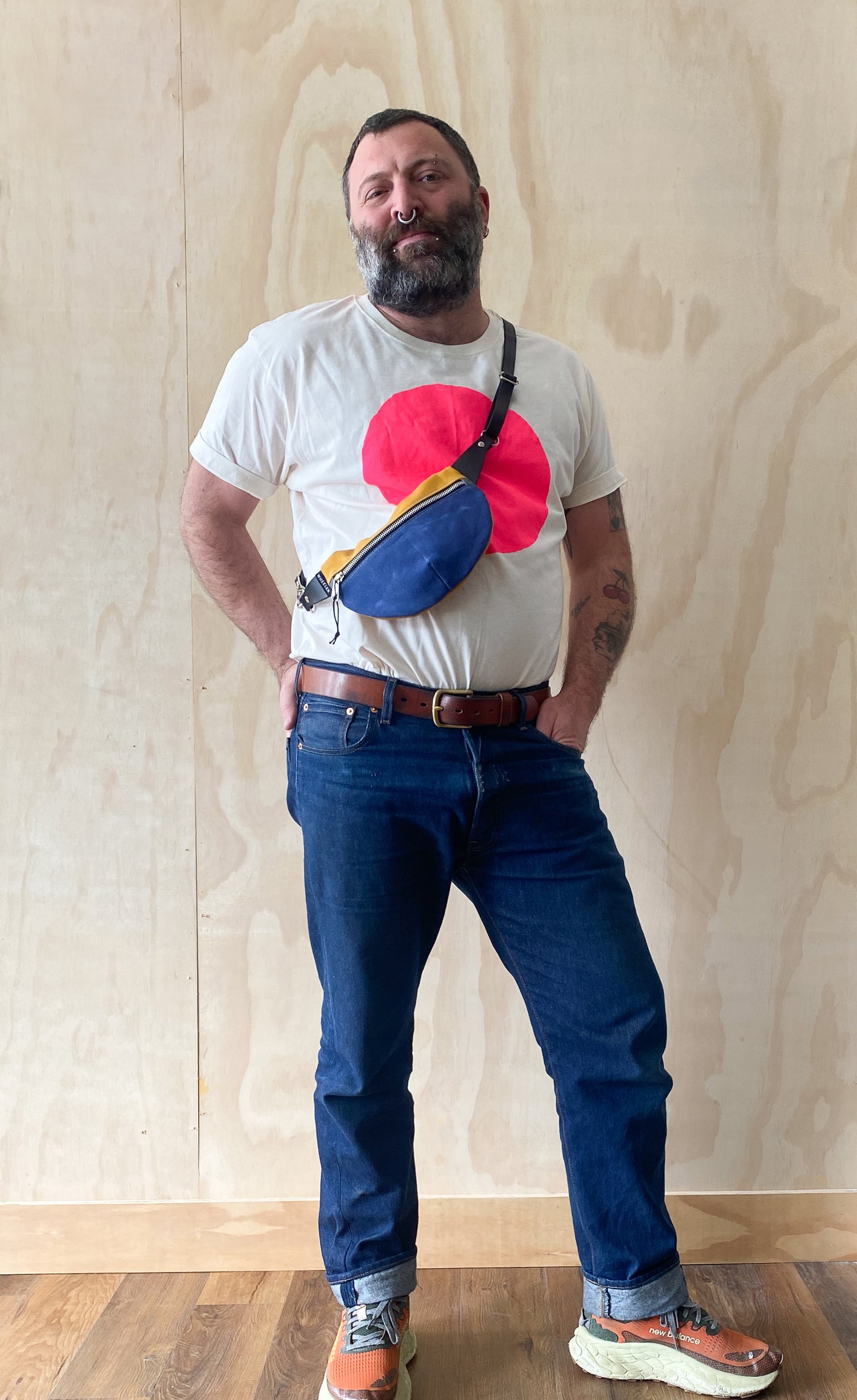 Waxed canvas fanny pack worn crossbody, showing alternate styling