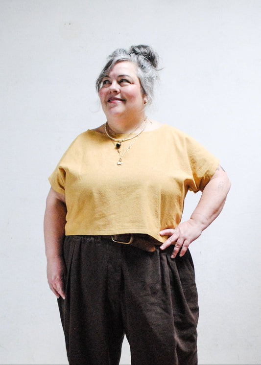 Model wearing Goldie crop tee with hand on hip