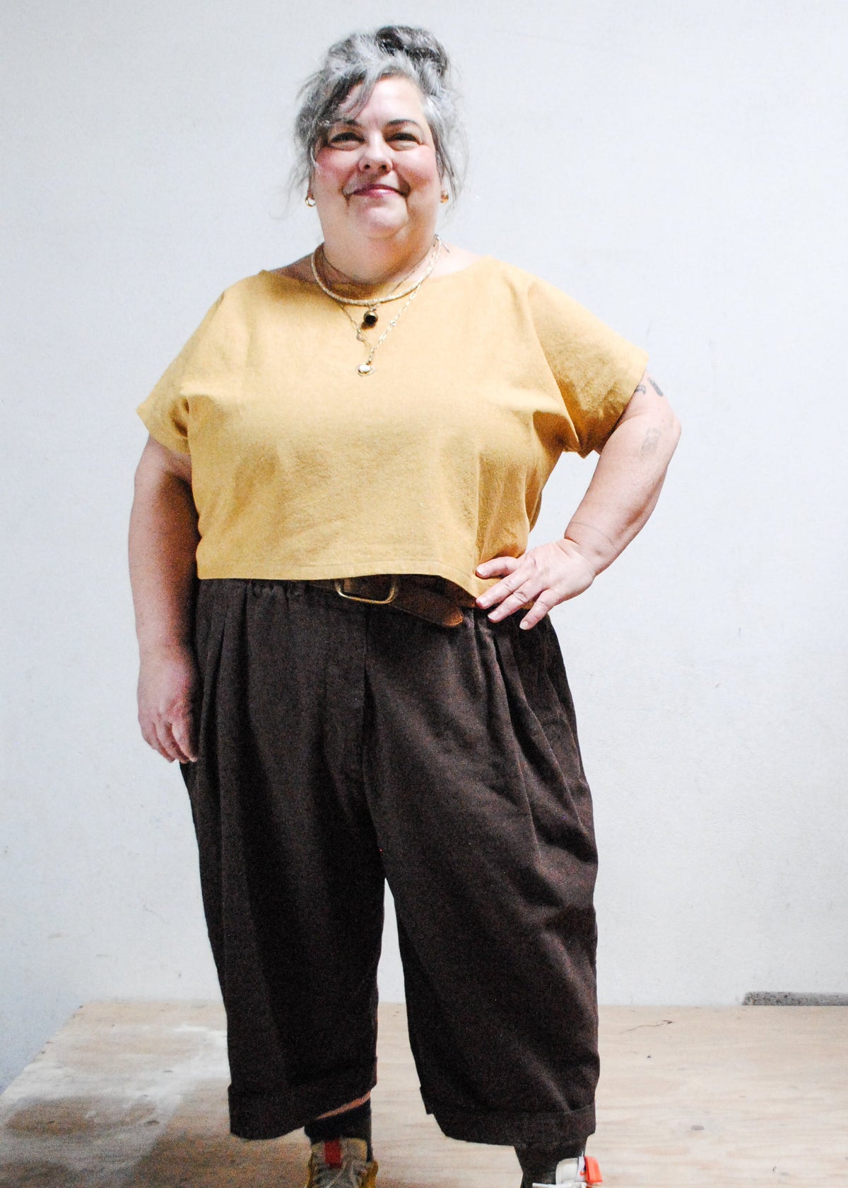 Model wearing Goldie crop tee with hand on hip