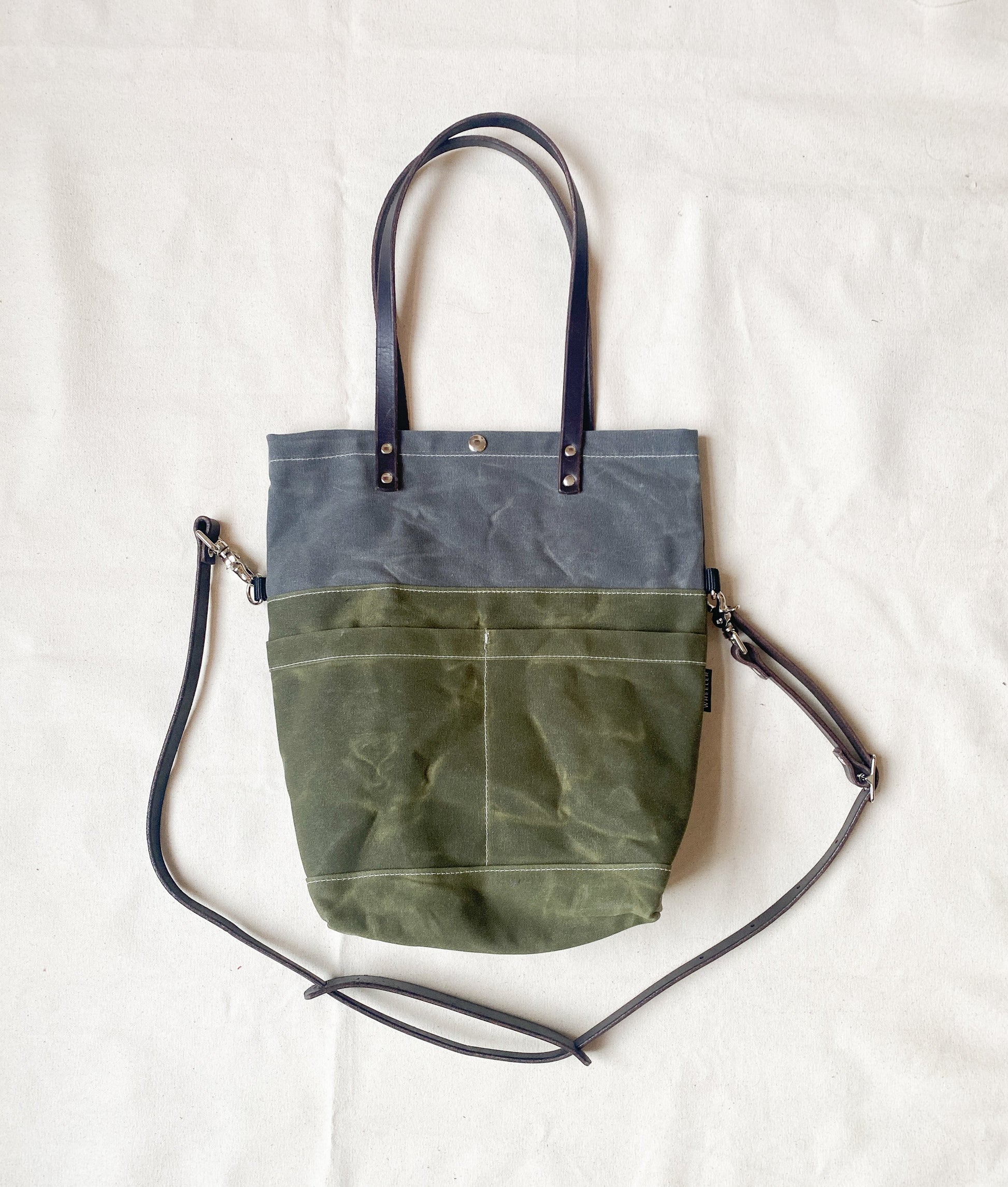 Large bag for every day use. Handles fold down to side when carried crossbody in Slate and Olive. 
