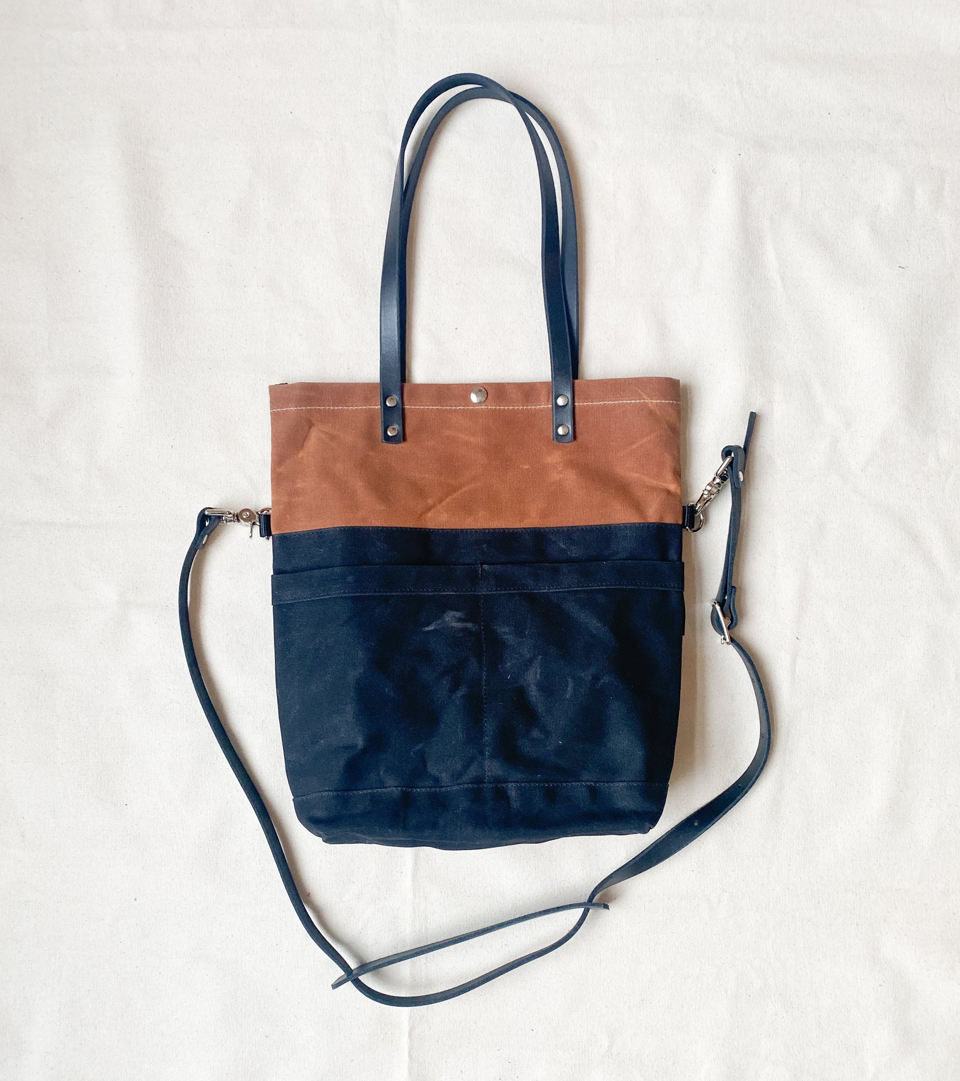 Convertible tote in tan and charcoal.