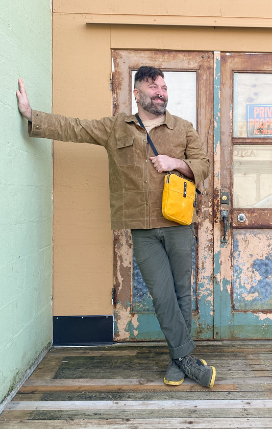 Model in Waxed Canvas Work Jacket in tan, buttoned. 