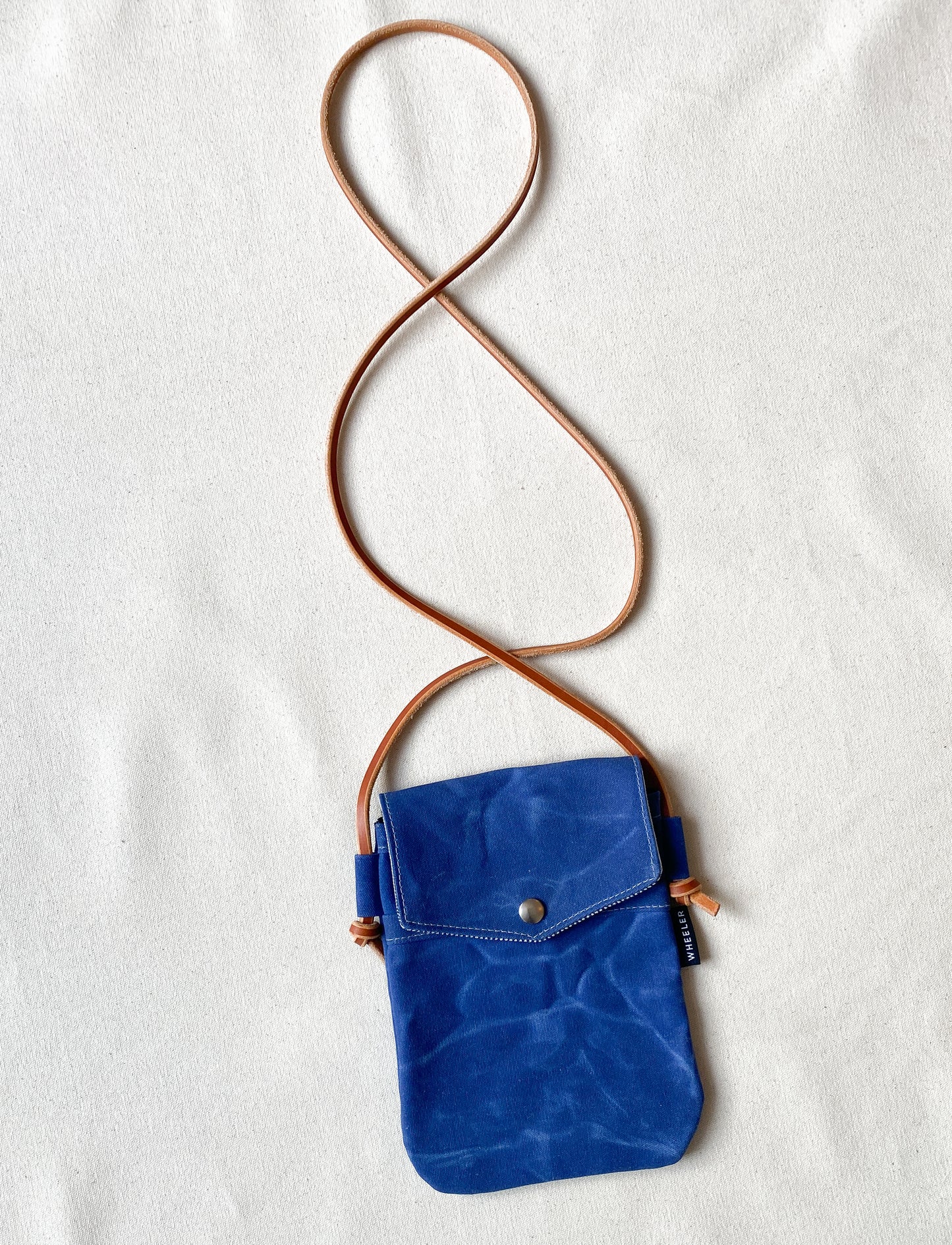 Waxed Canvas Simple Crossbody in all blue. 