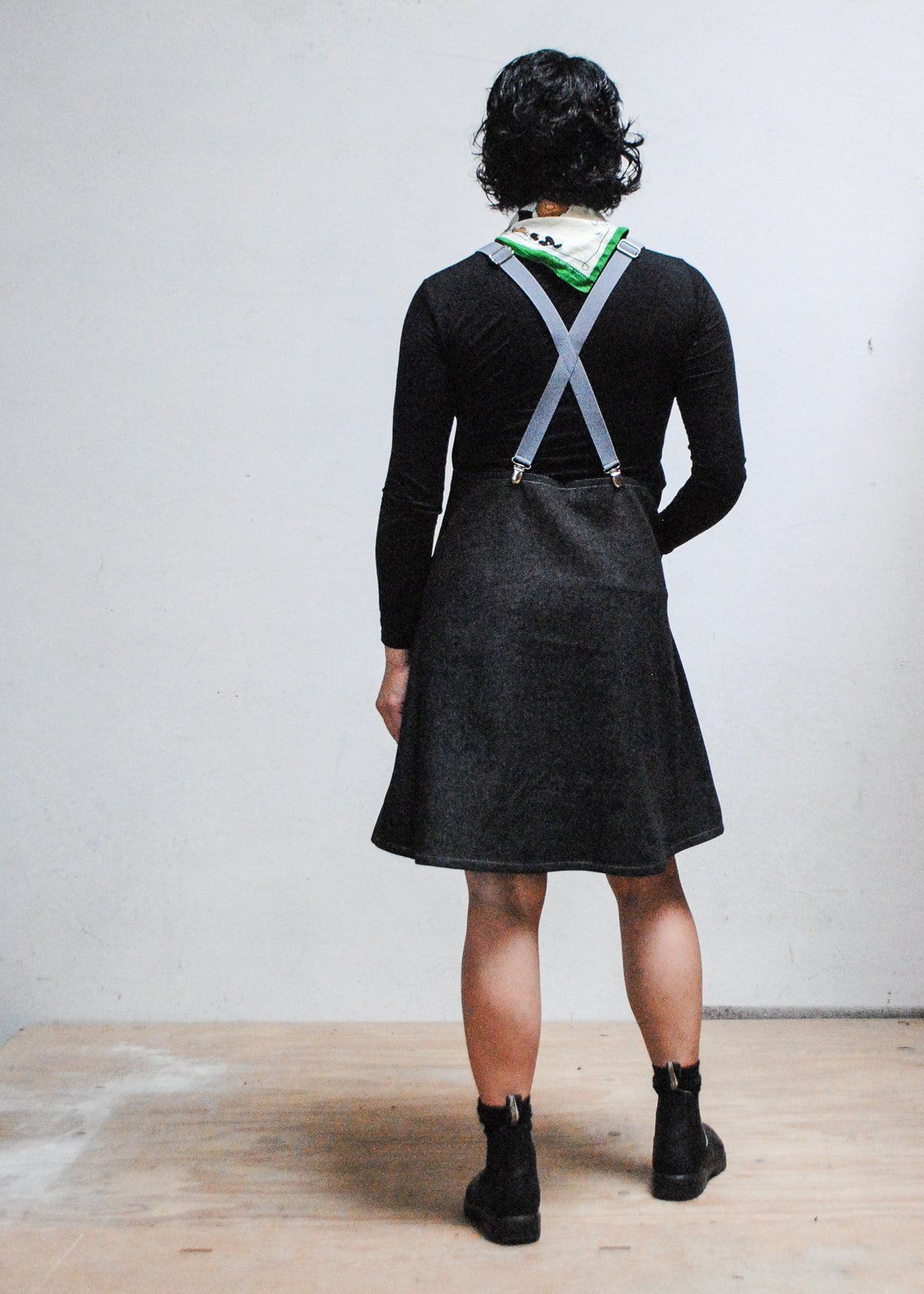 Handmade black denim suspender dress with grey adjustable suspenders, knee-length pinafore style - back view