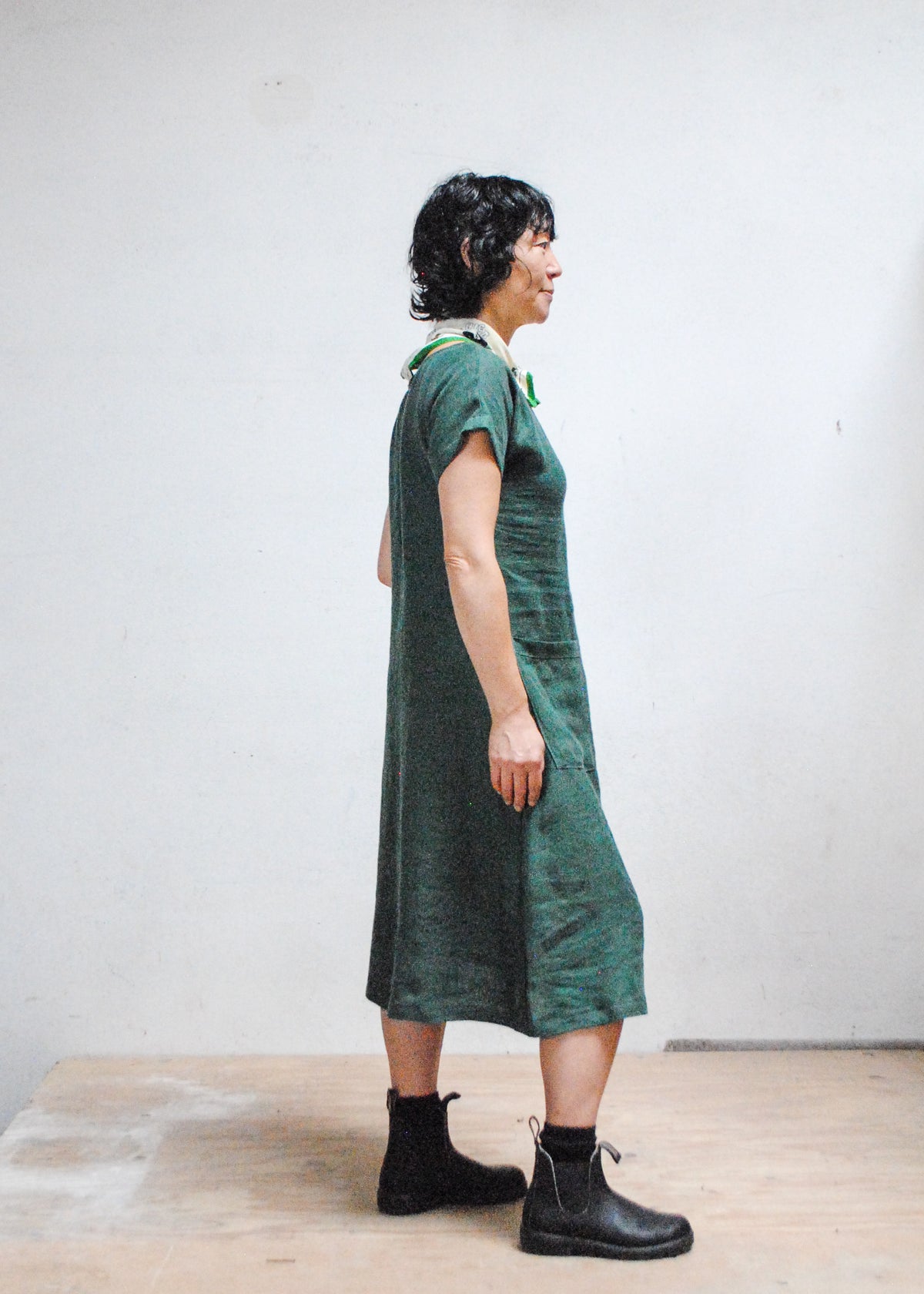 Model wearing Shift + Wheeler Basic Dress in green linen - side view