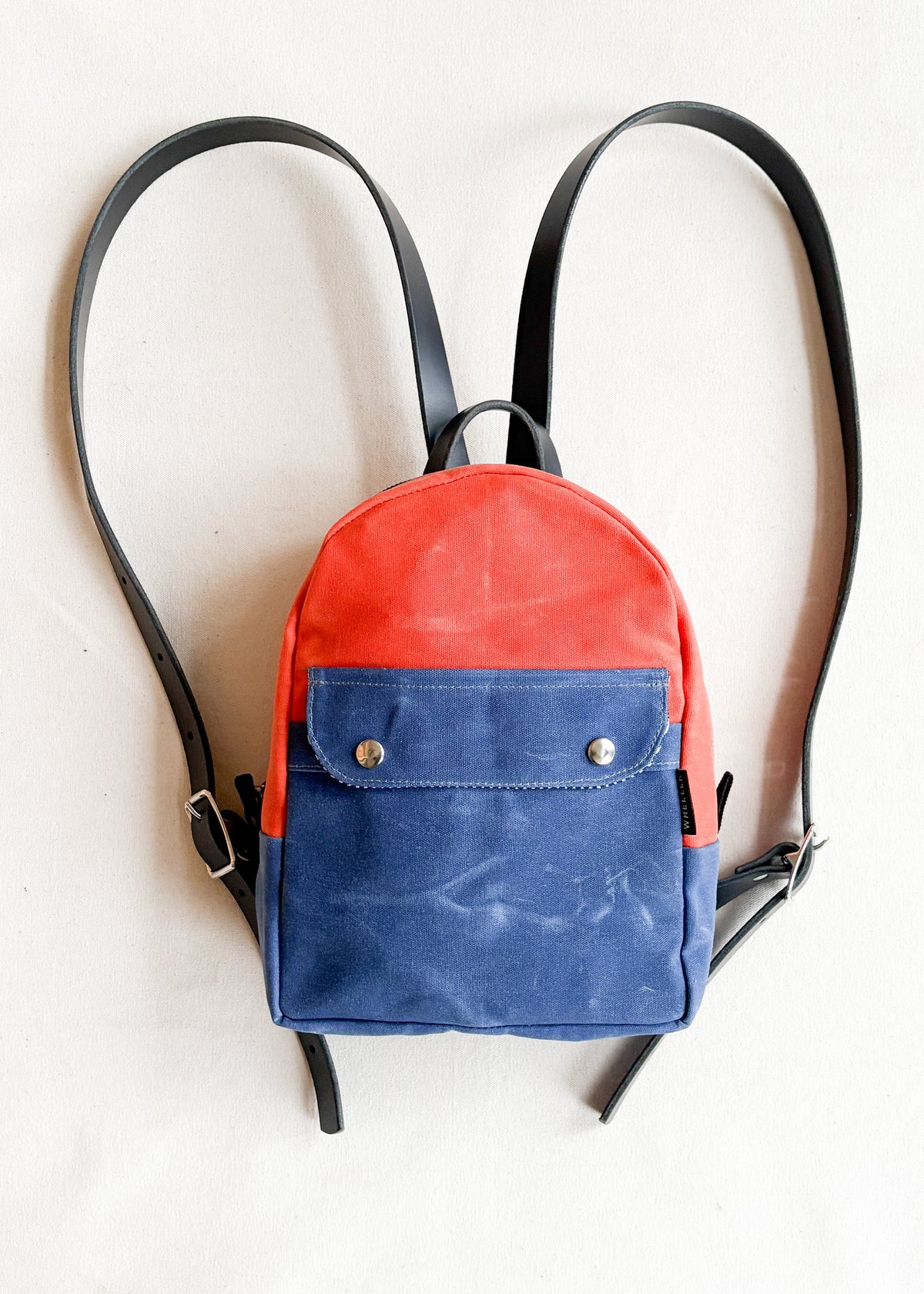 2-tone orange and royal handmade Shift + Wheeler waxed canvas mini backpack 