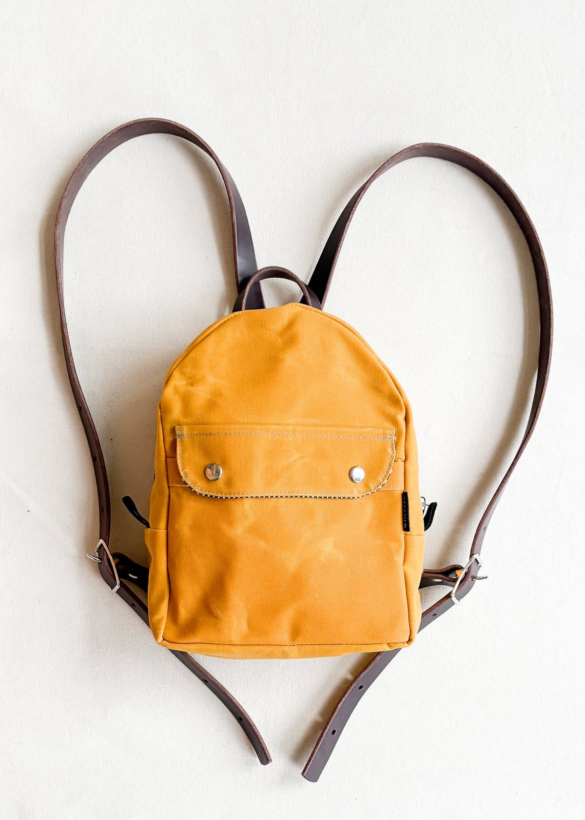 2-tone yellow gold handmade Shift + Wheeler waxed canvas mini backpack 