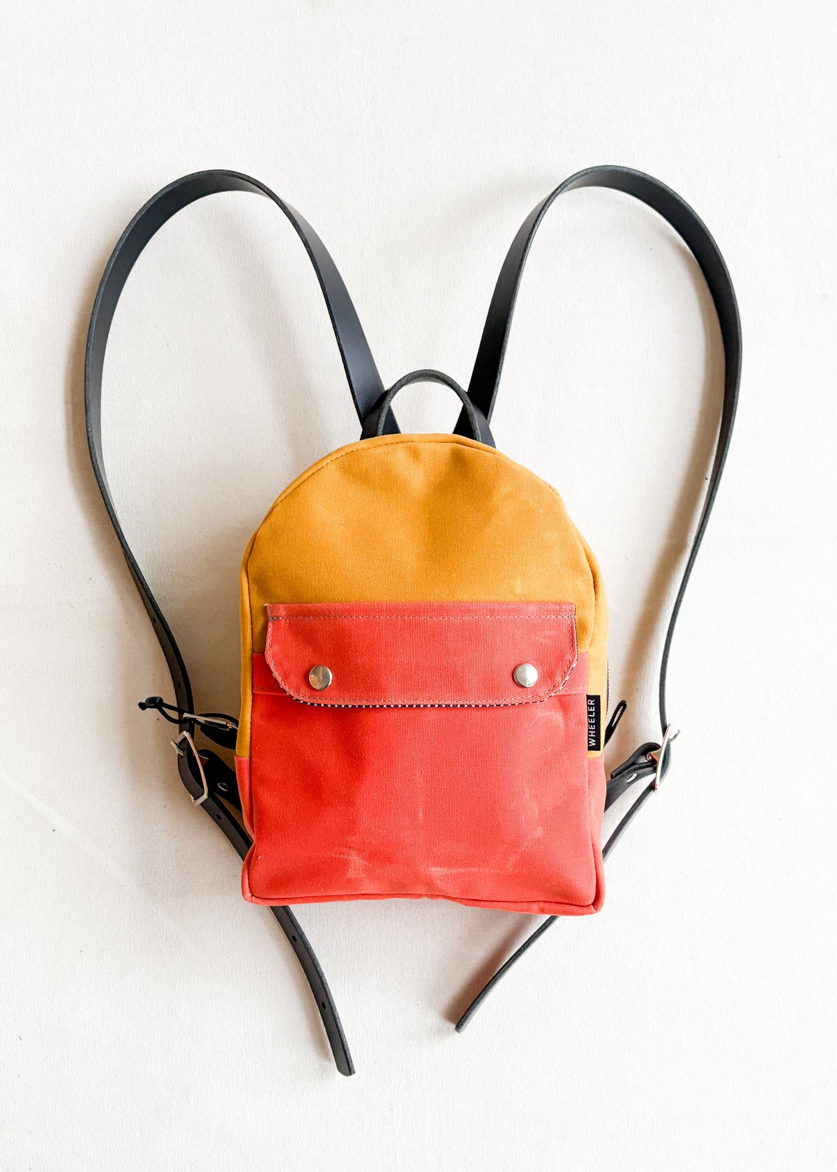 2-tone orange and yellow gold handmade Shift + Wheeler waxed canvas mini backpack 