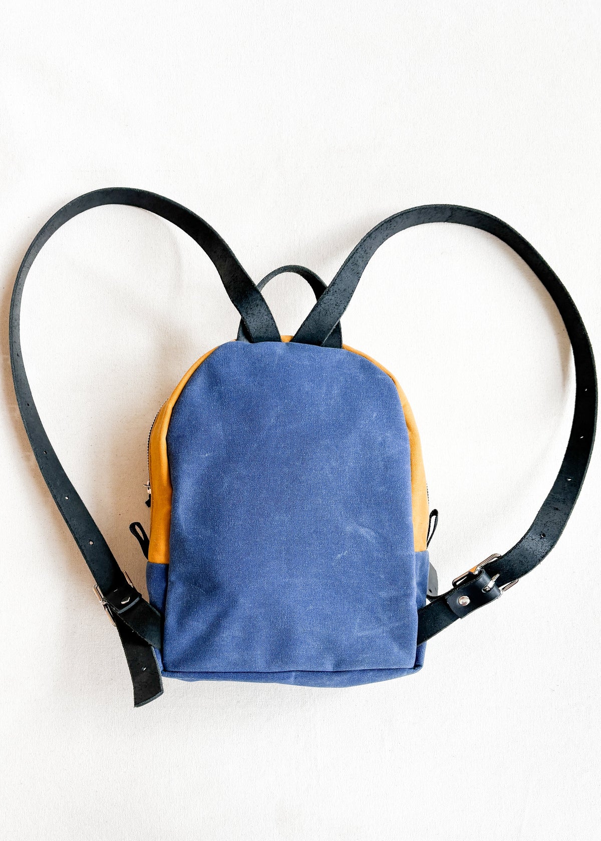 2-tone yellow gold and royal blue handmade Shift + Wheeler waxed canvas mini backpack - back view