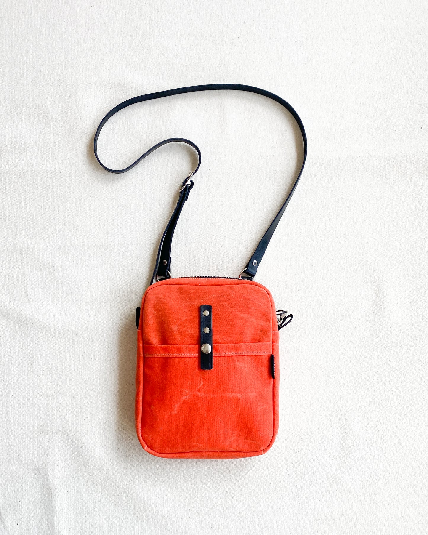 Waxed canvas mini messenger bag in orange