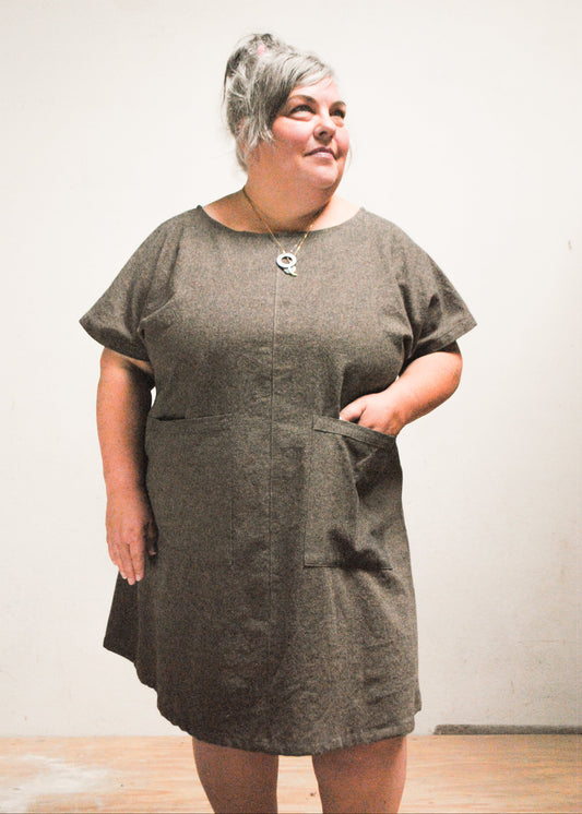 Model wearing handmade Shift + Wheeler mini dress in Espresso, one hand in dress pocket
