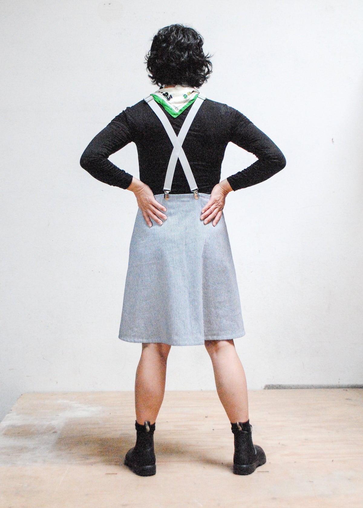 Model wearing handmade railroad stripe suspender dress - back view