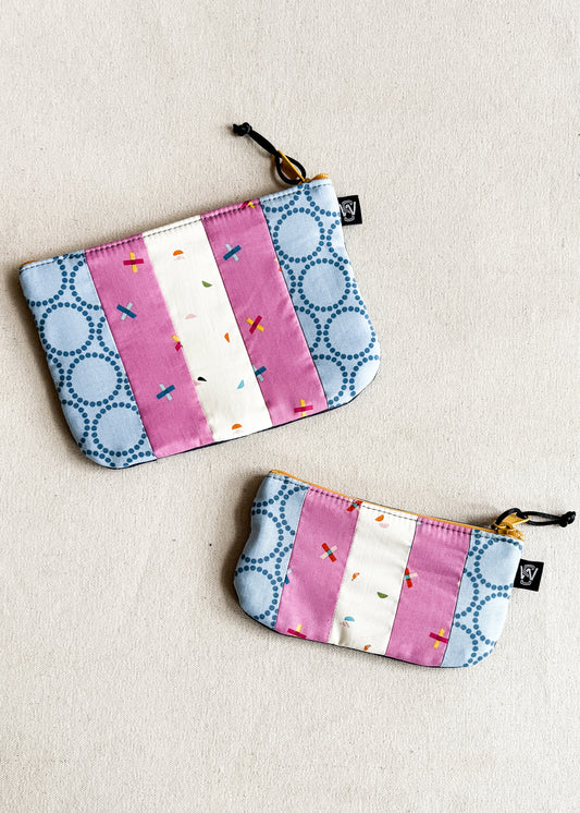 2 zipper pouches made out of scrap fabric with trans pride flag colors