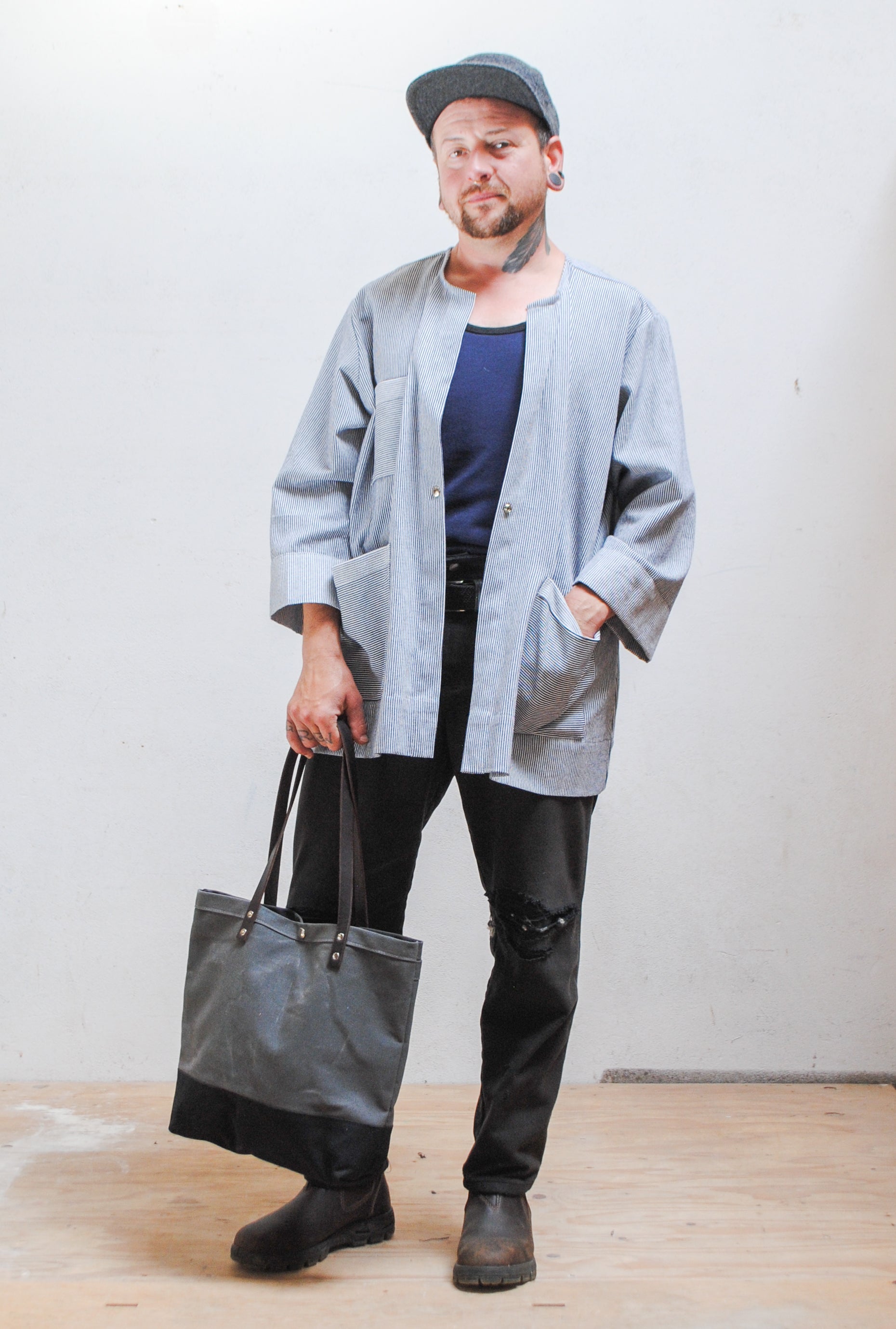 Grey and Black tote held at arms length. 