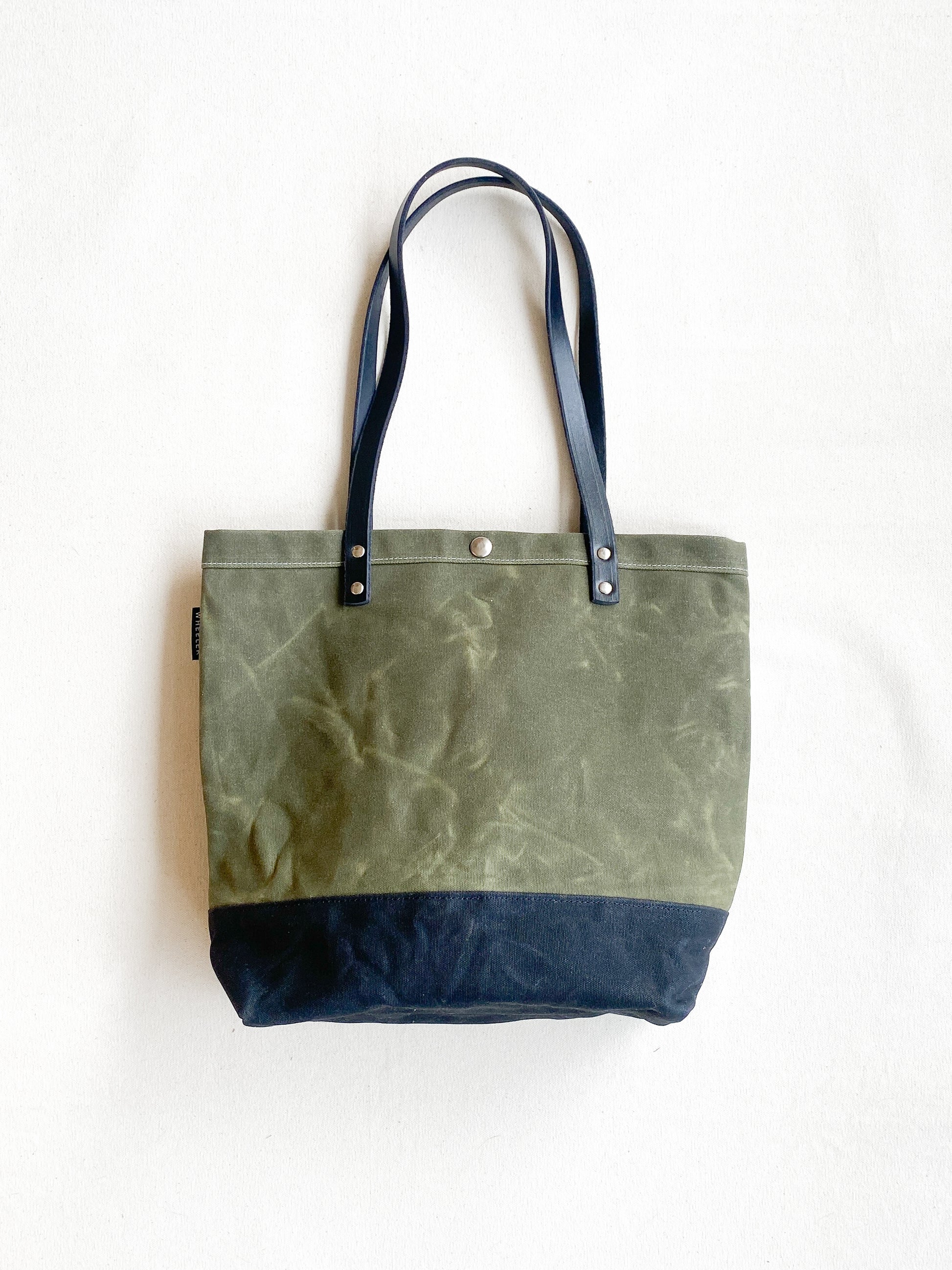 Olive and black tote with leather handles. Waxed Canvas and railroad denim on the inside. 