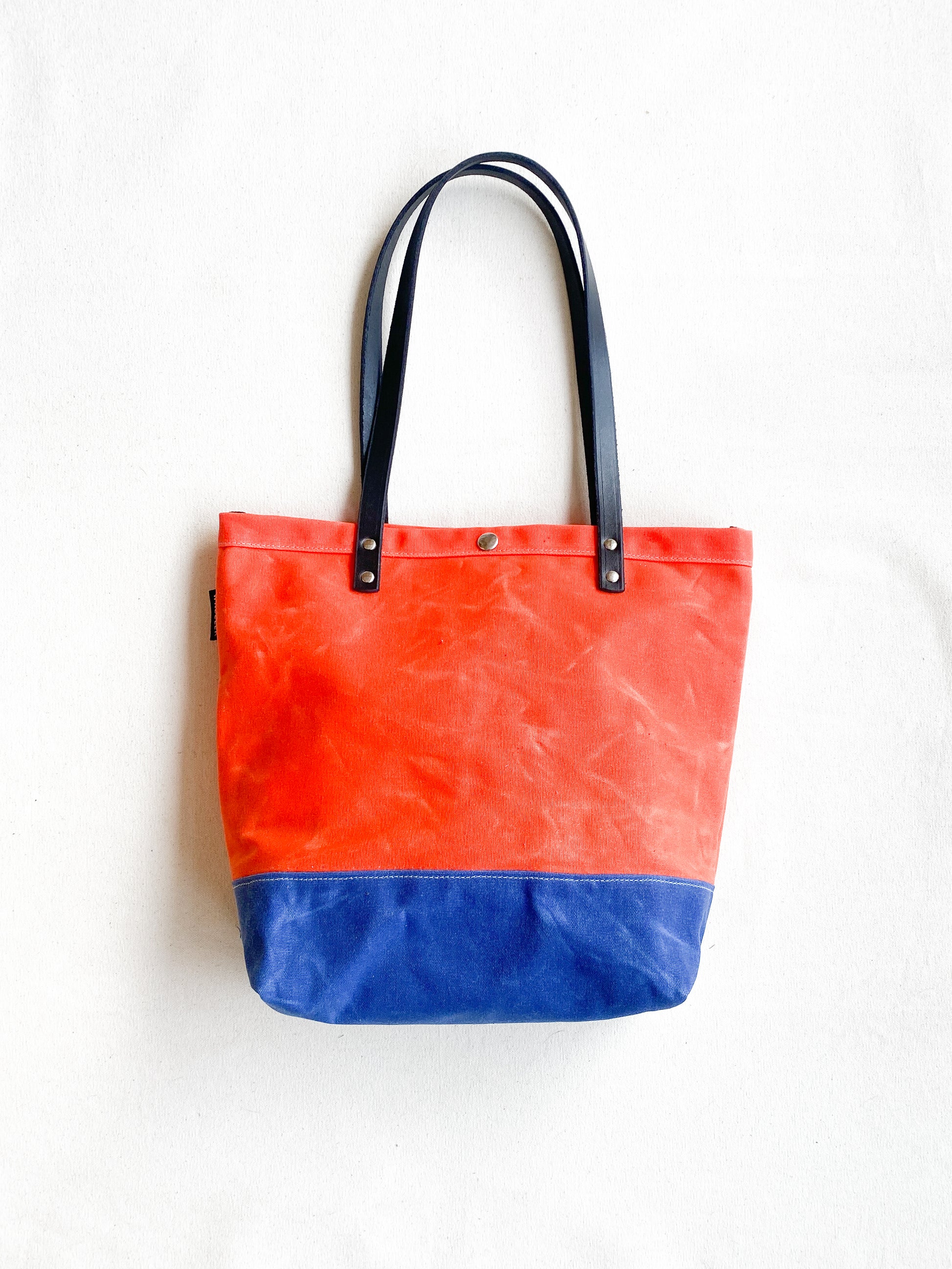 Bright orange and Royal blue waxed canvas tote with railroad denim lining. 