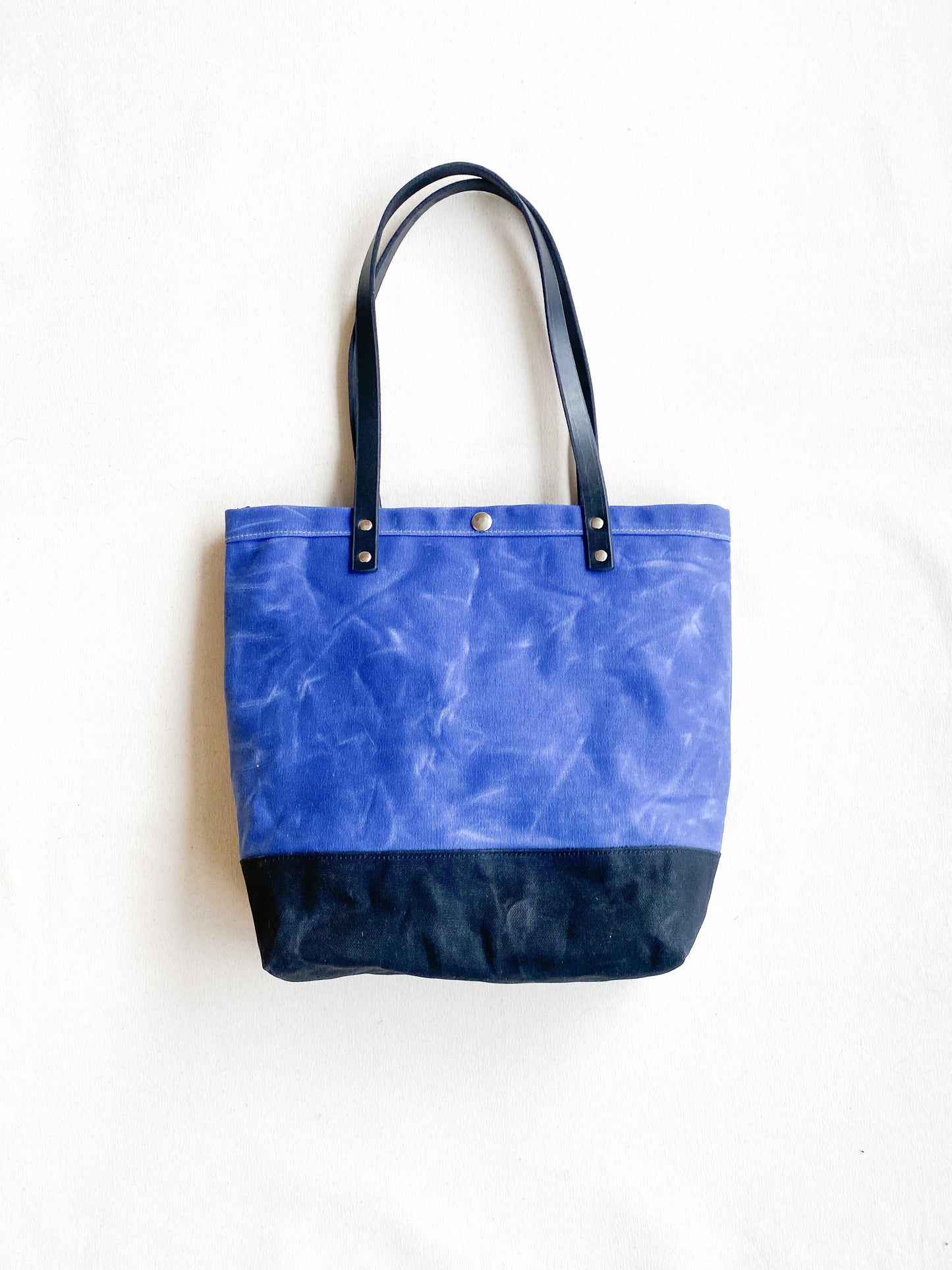 Blue and black waxed canvas utility tote. 