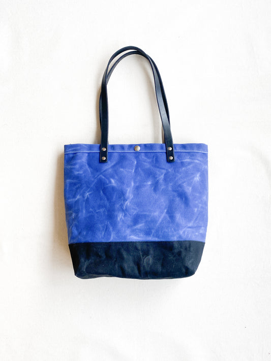 Blue and black waxed canvas utility tote. 