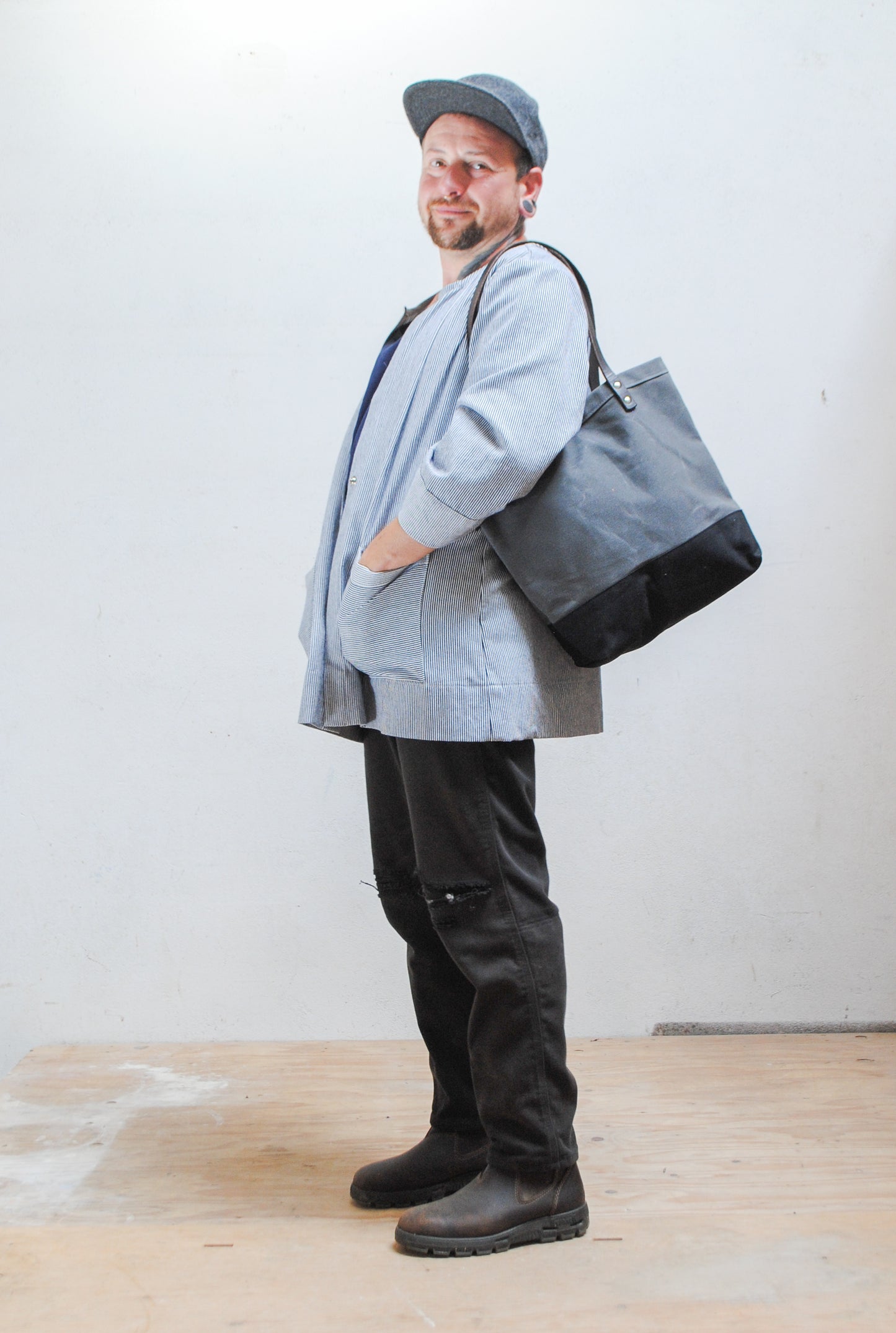 The utility tote has handles long enough so you can sling the bag over your shoulder. 