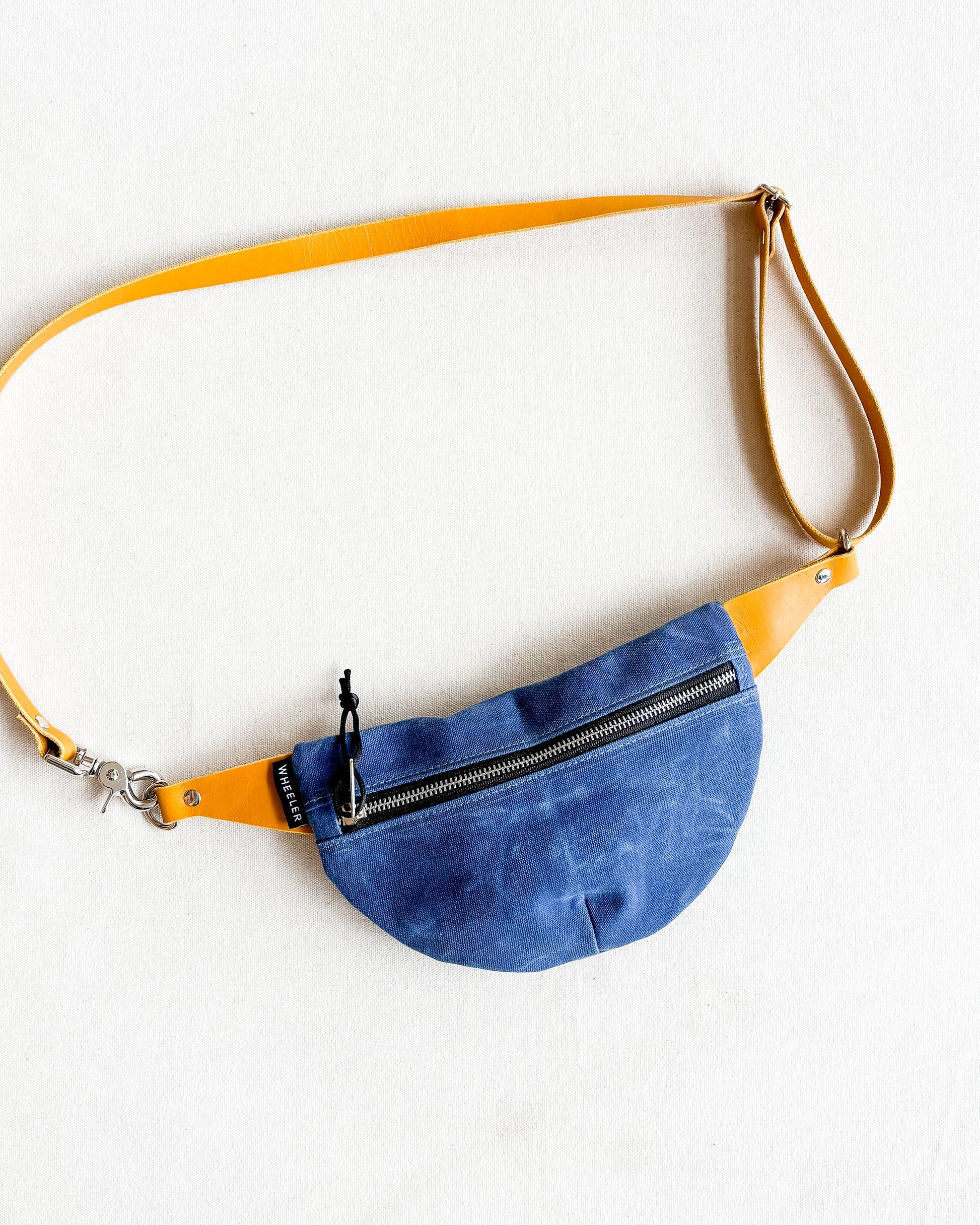 Blue belt bag with yellow strap.