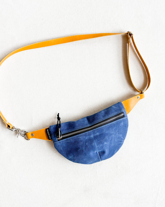 Blue belt bag with yellow strap.