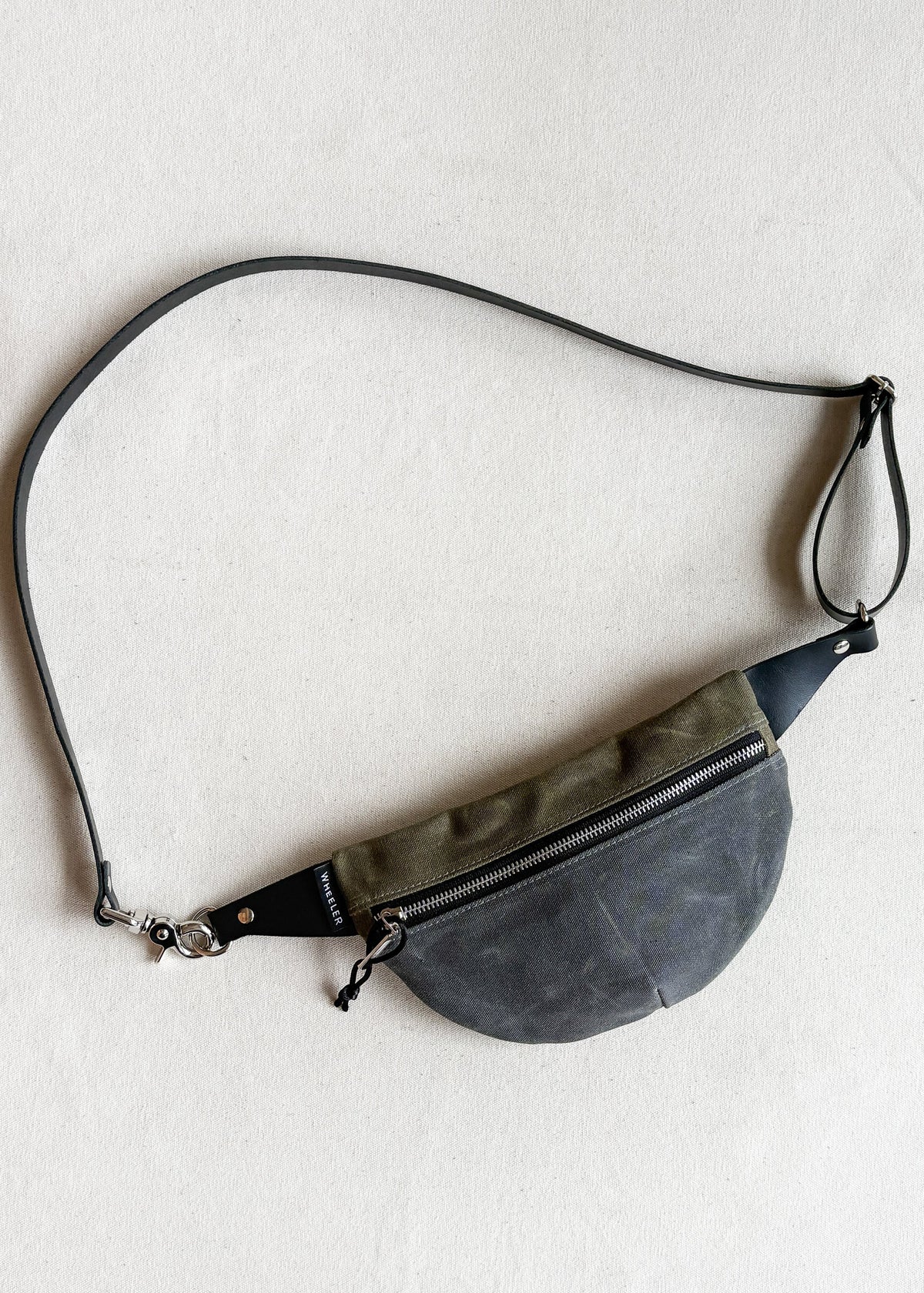 Handmade waxed canvas fanny pack in two-tone (charcoal and olive) with black leather strap