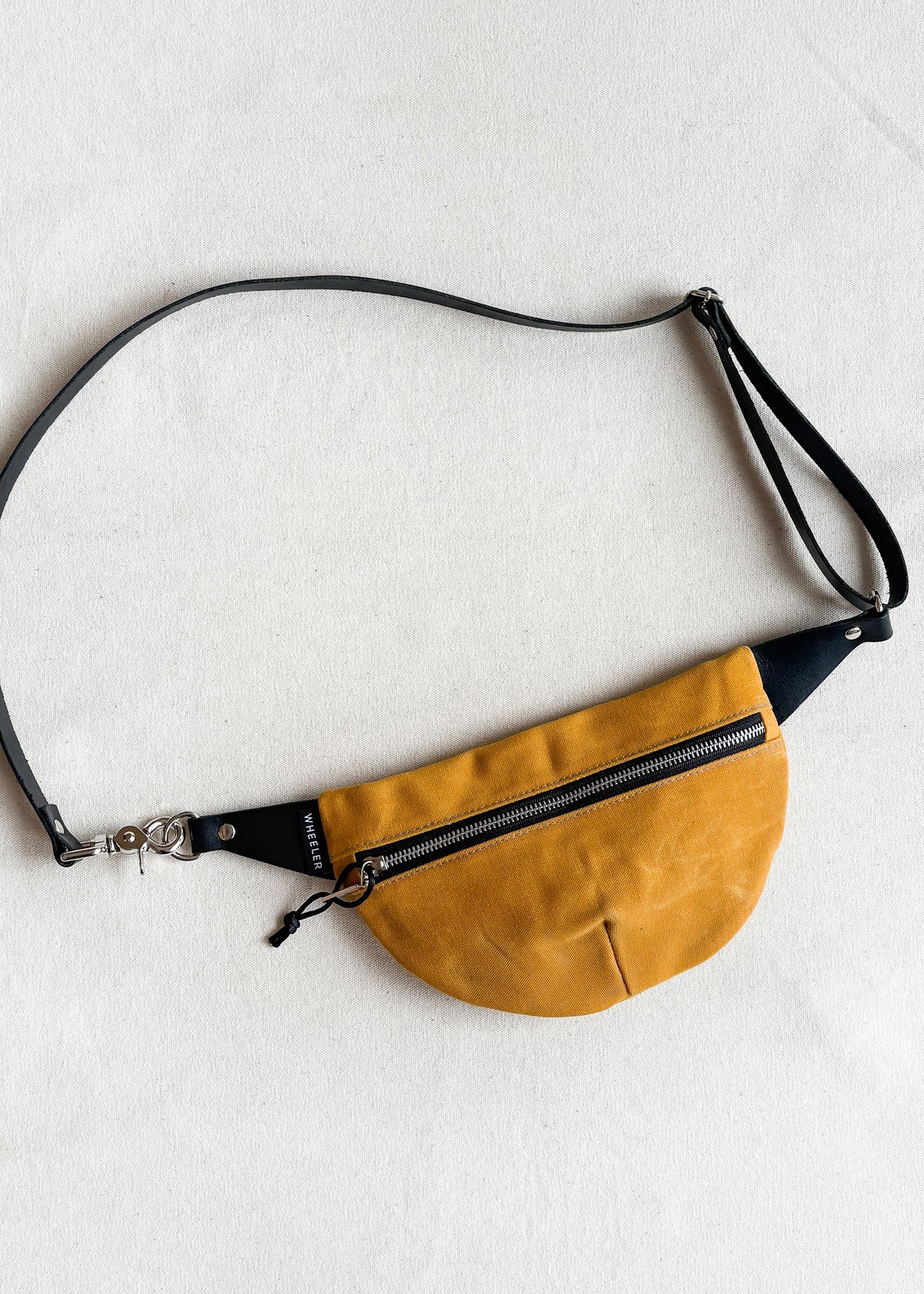 Handmade waxed canvas fanny pack in gold with black leather strap