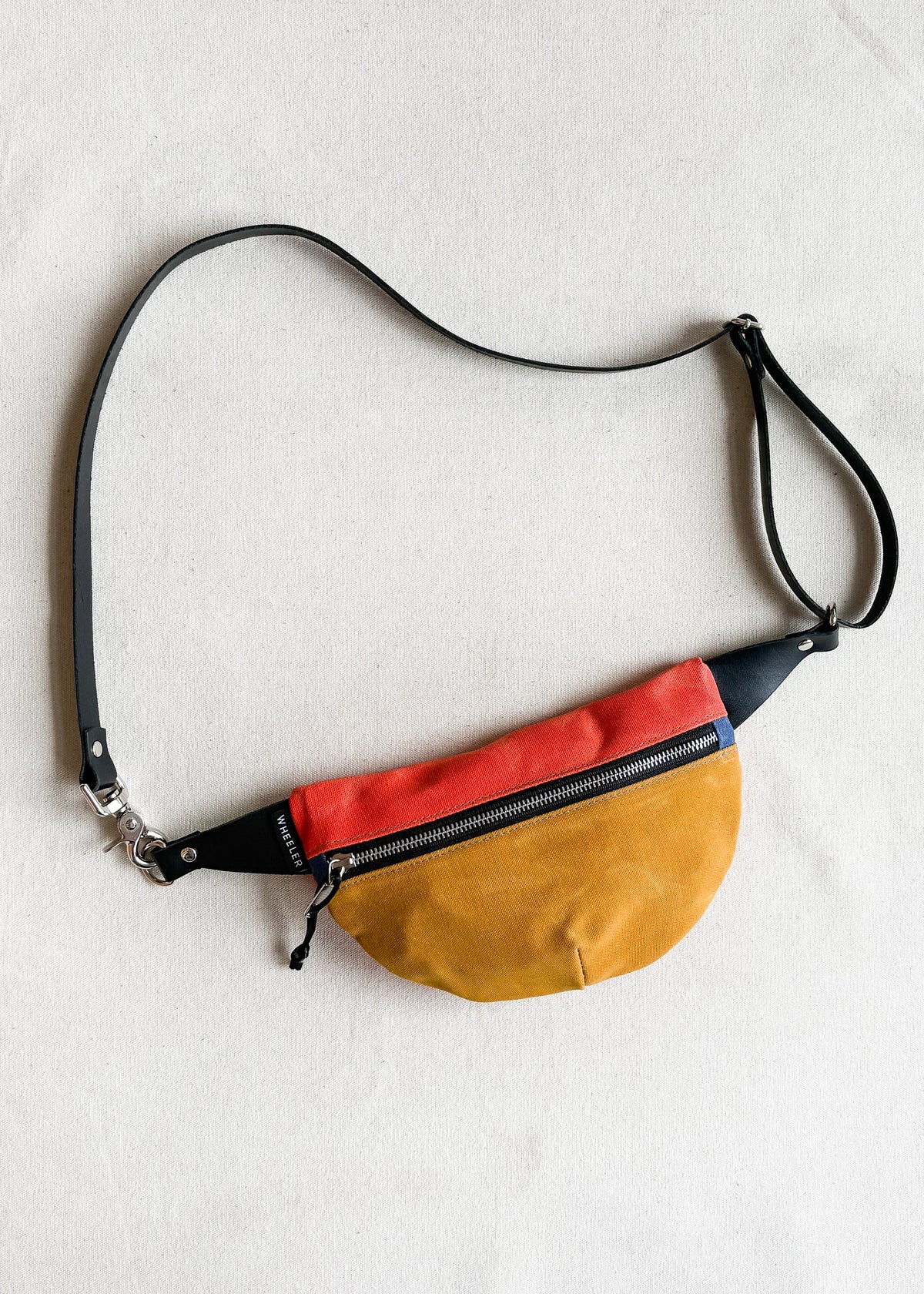 Handmade waxed canvas fanny pack in two-tone (gold and orange) with black leather strap