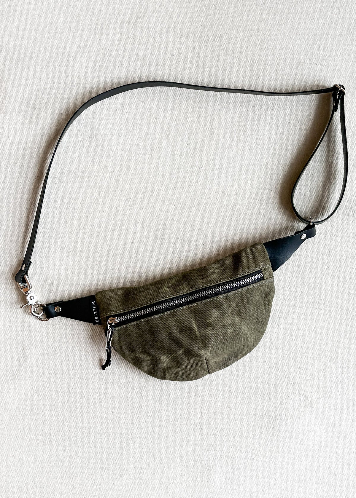 Handmade waxed canvas fanny pack in olive green
